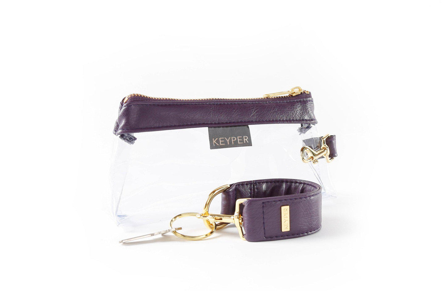 The Pretty Purple Vegan Leather 2-Piece WRISTLET SET by KEYPER features a wristlet with a zipper and gold accents, plus a detachable strap, and comes next to keys on a silver keyring.
