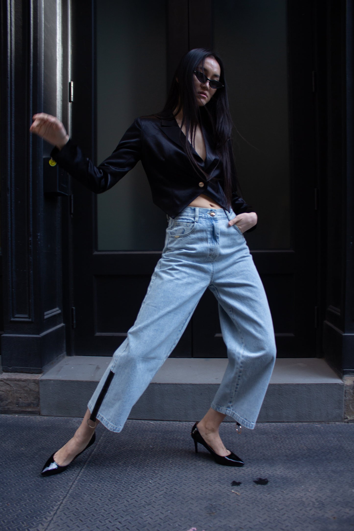 Le Réussi® Demi Straight Cut Jeans feature a high waist, wide legs, and are adorned with stylish black zipper details at the hem in a light blue denim fabric.