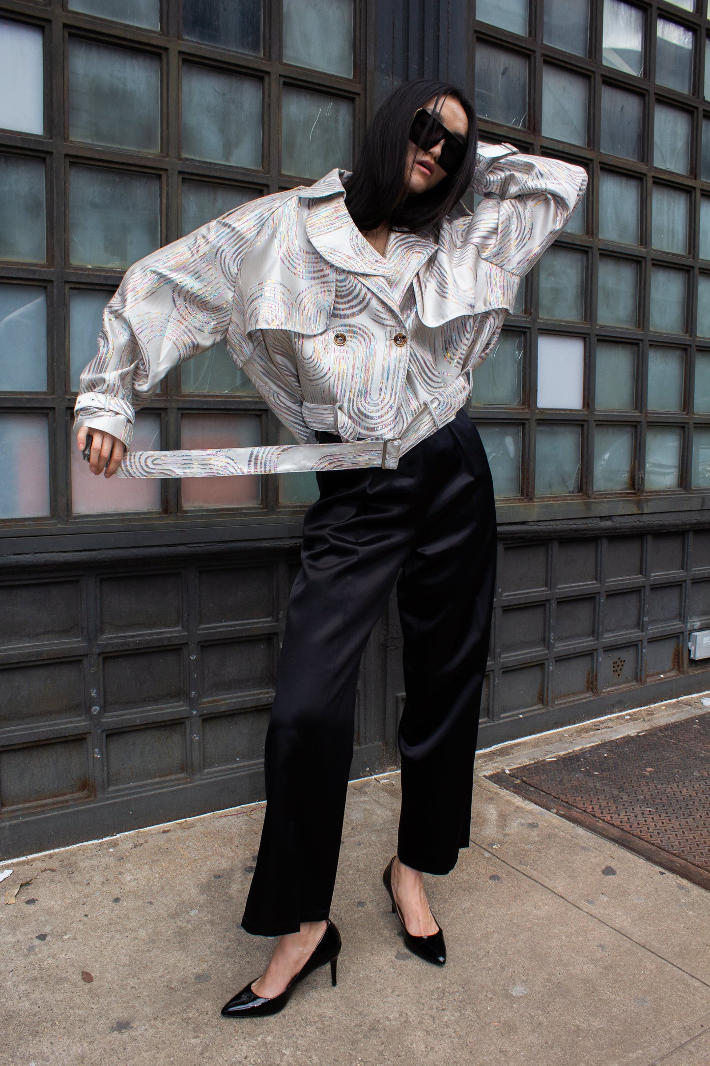 Jacqueline Beige Jacket by Le Réussi® features a white and silver pattern in a double-breasted design with a belt and buttoned cuffs, shown against a white background.