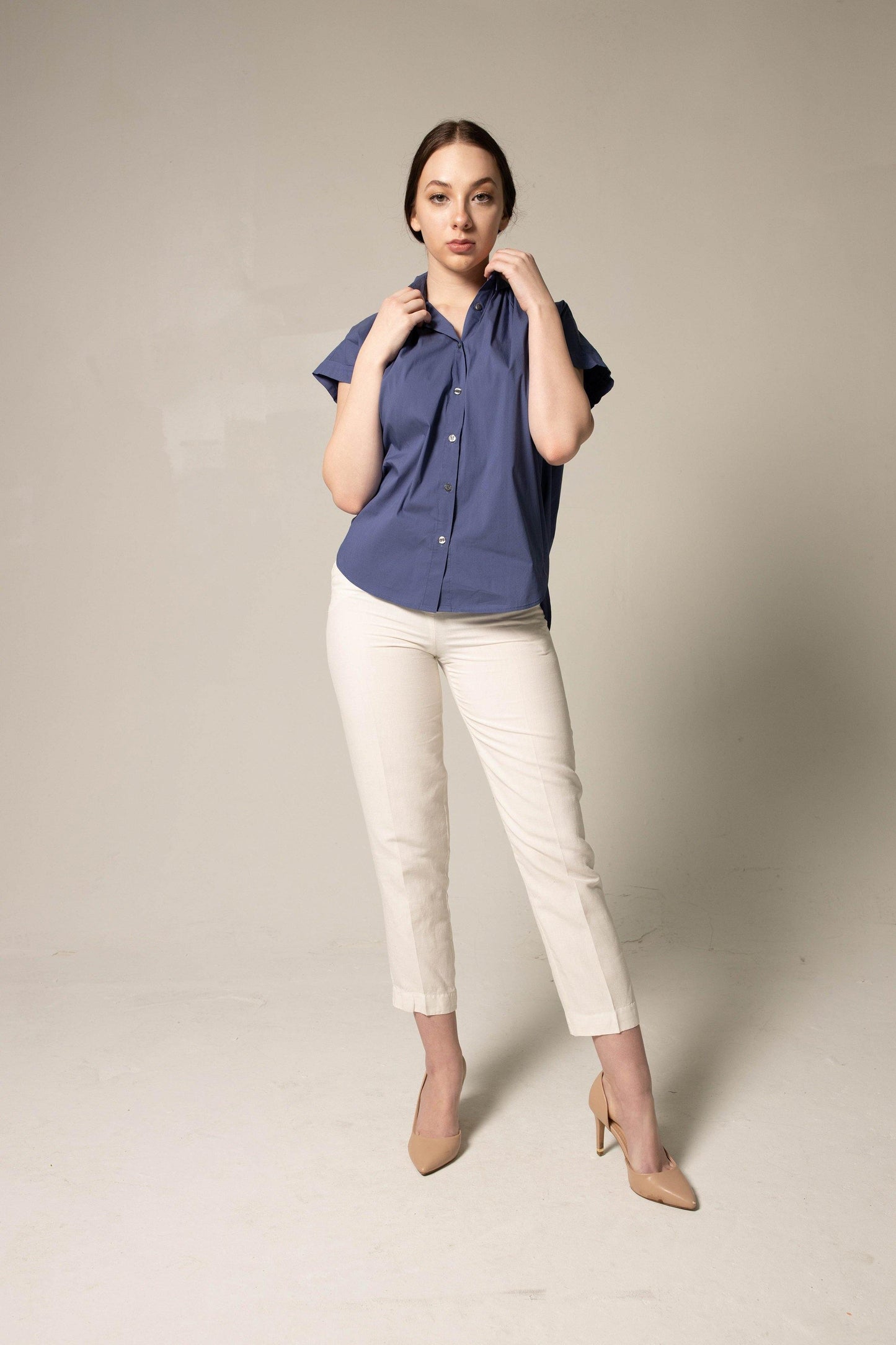 A person wearing Le Réussi® Womens Gather Collar Shirt in Navy and light pants stands against a plain background.
