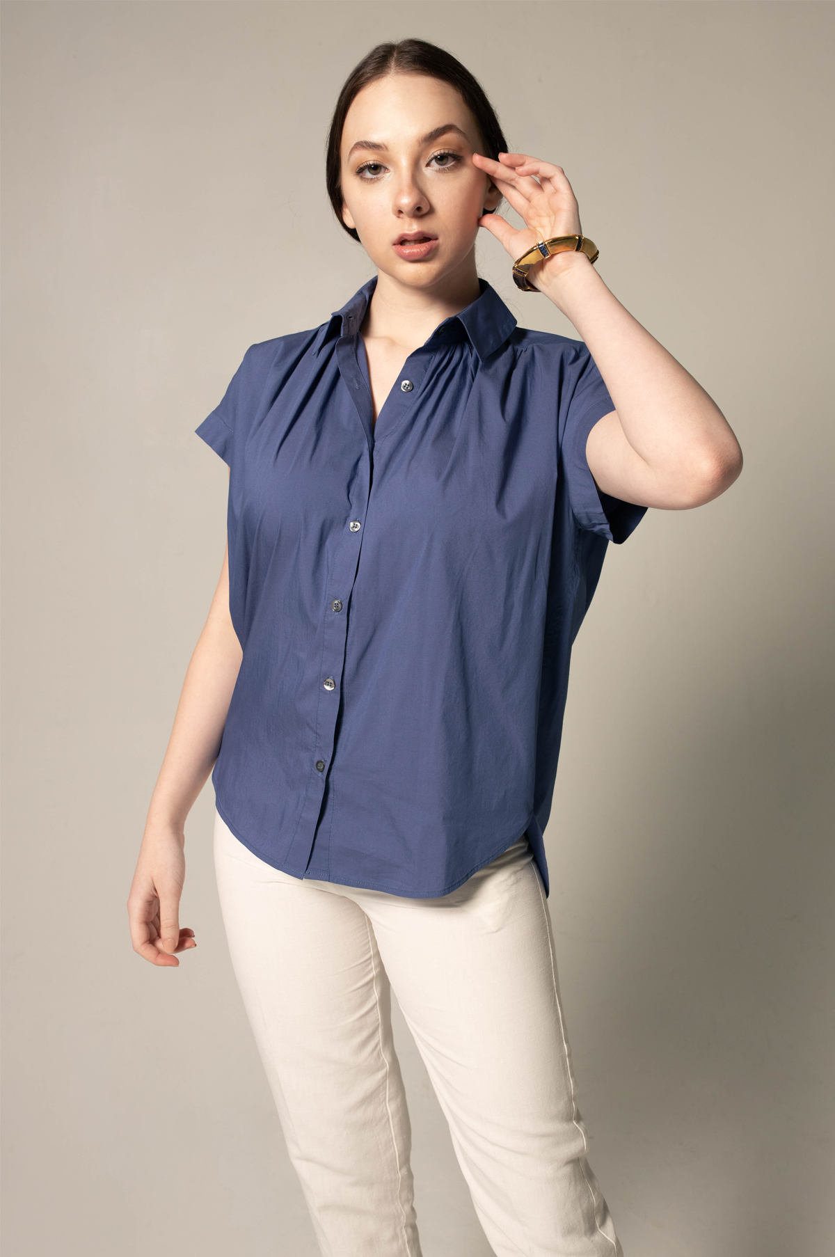 A person wearing Le Réussi® Womens Gather Collar Shirt in Navy and light pants stands against a plain background.