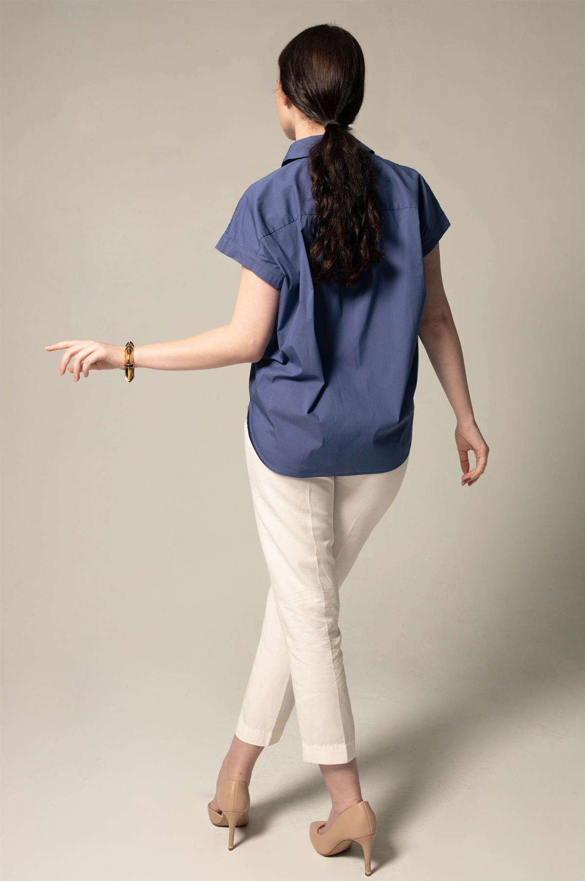 A person wearing Le Réussi® Womens Gather Collar Shirt in Navy and light pants stands against a plain background.