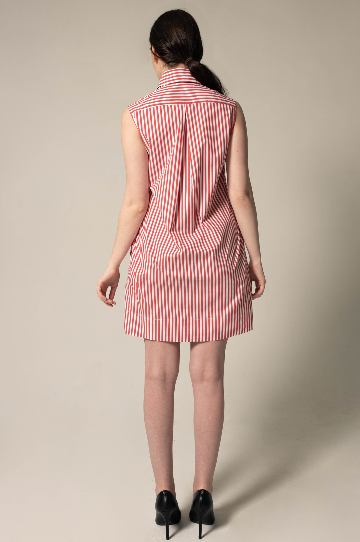 A person in a Le Réussi® Italian Cotton Red Stripe Sleeveless Dress and black heels stands against a plain background.