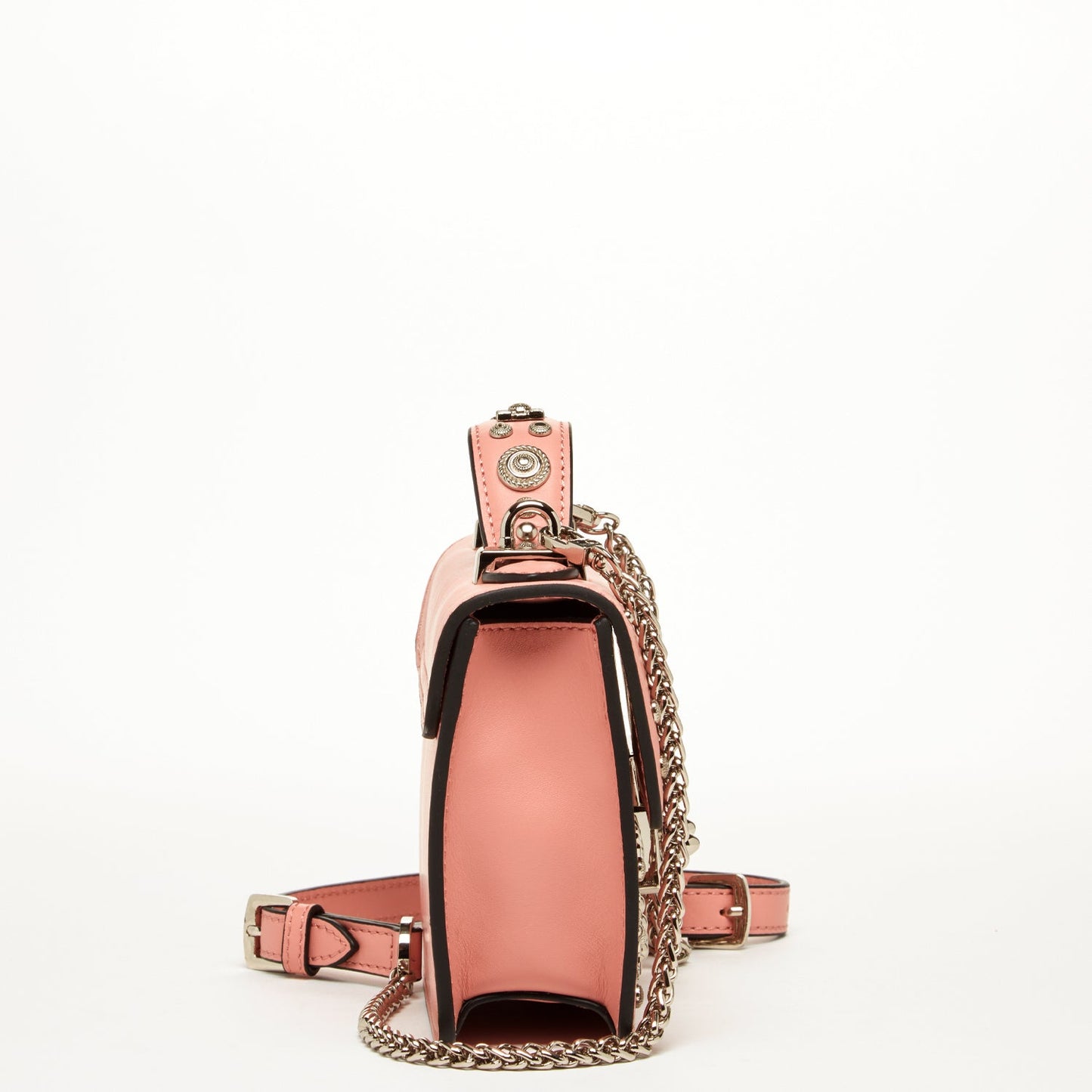 The Hollywood Leather Crossbody Bag Pale Pink by SUSU features metal studs, decorative patterns, a chain strap, and a buckle closure.