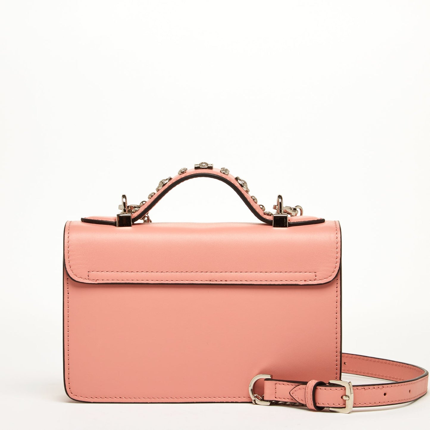 The Hollywood Leather Crossbody Bag Pale Pink by SUSU features metal studs, decorative patterns, a chain strap, and a buckle closure.