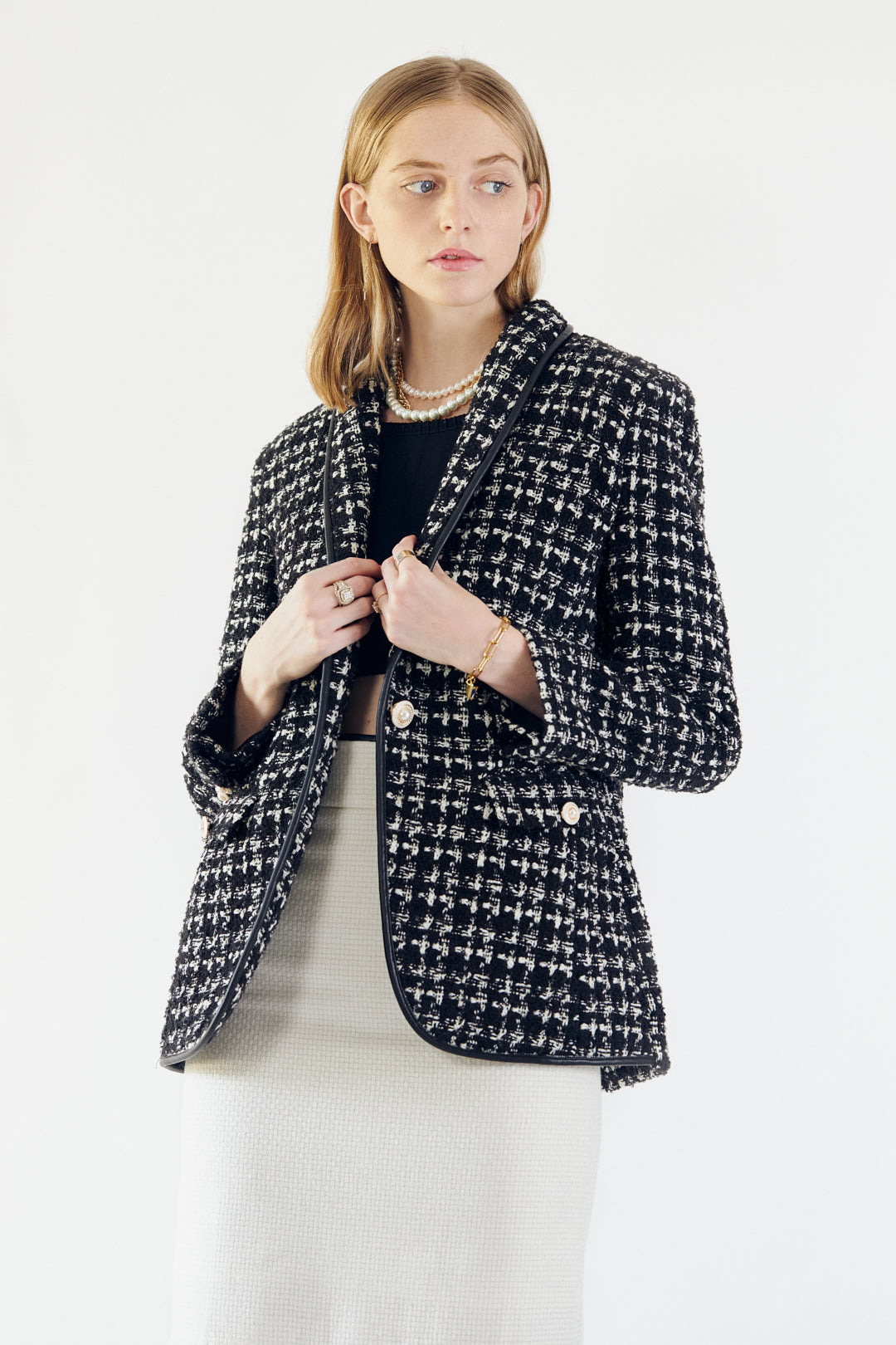 Close-up of Le Réussi®s Power Woman Black & White Tweed Checkers Jacket featuring decorative pearl buttons.