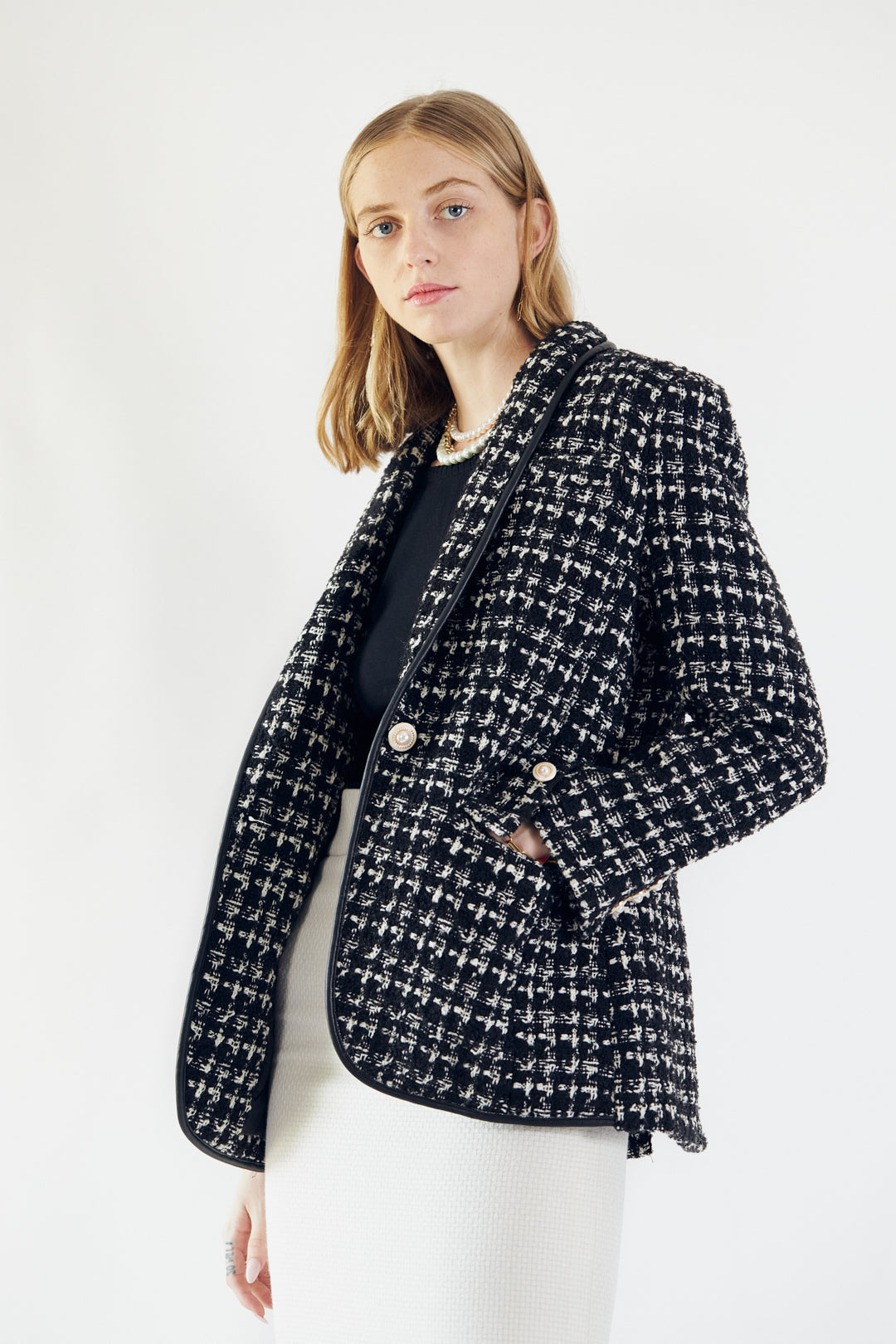 Close-up of Le Réussi®s Power Woman Black & White Tweed Checkers Jacket featuring decorative pearl buttons.