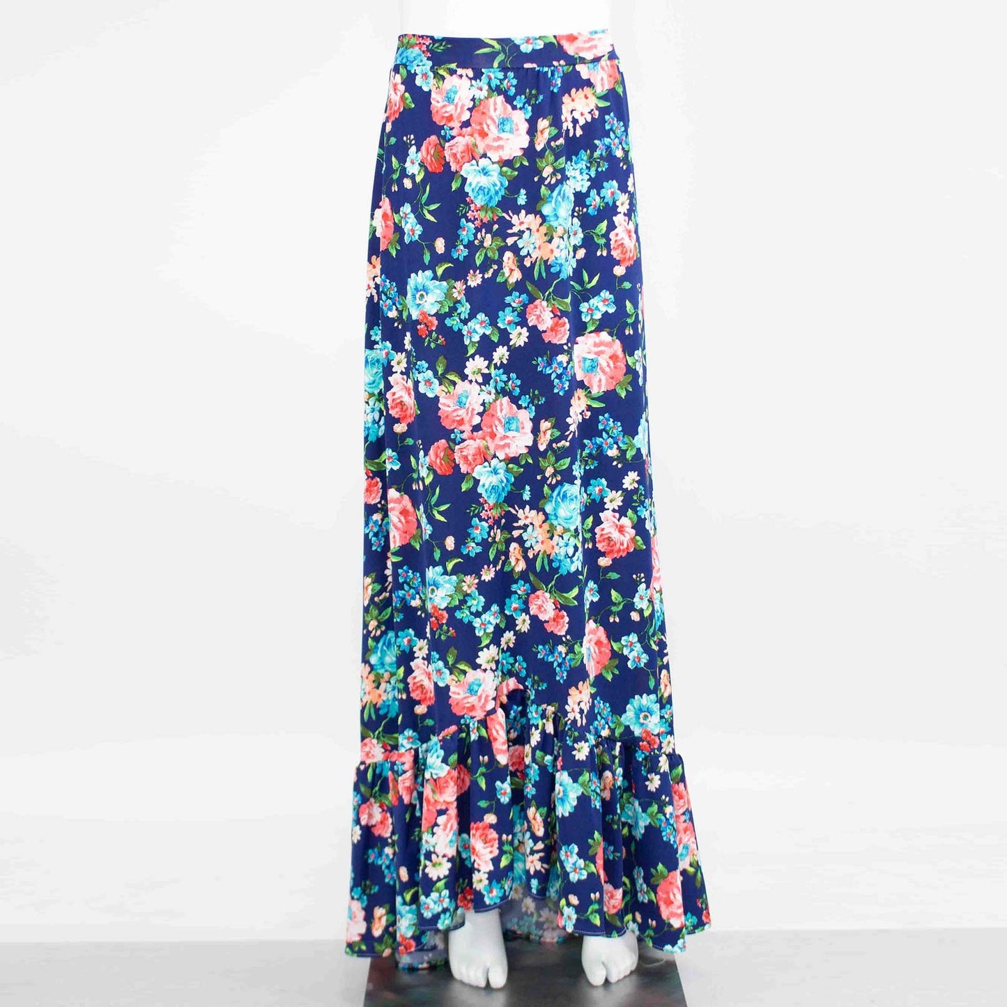 A Flared Bottom Flower Maxi Skirt by Stylespect, featuring a blue floral design and a ruffled hem, displayed on a mannequin.