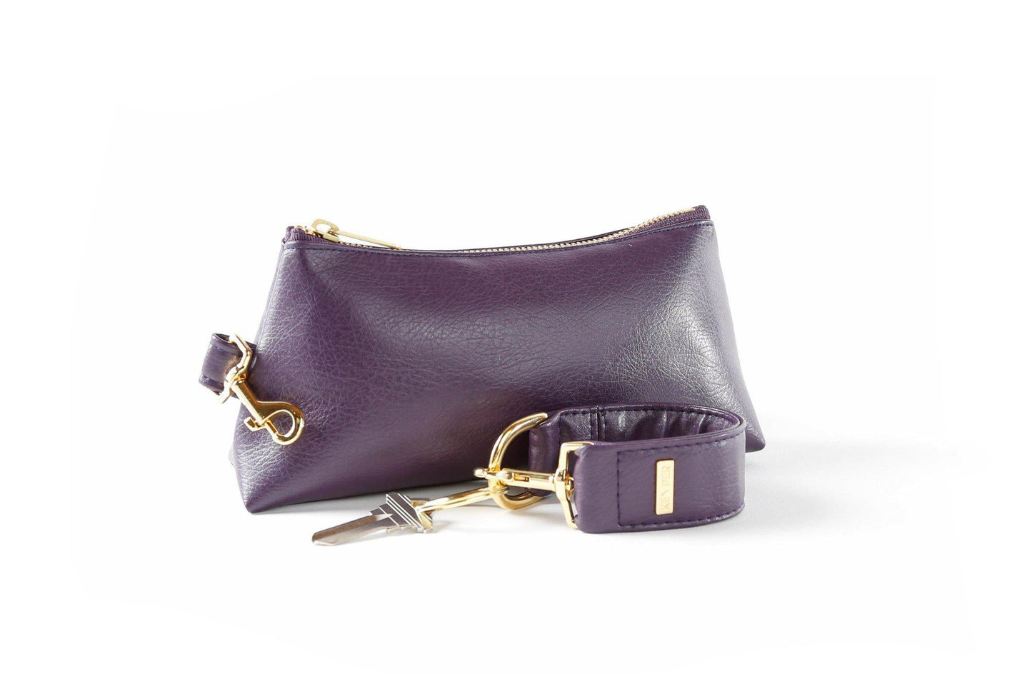 The Pretty Purple Vegan Leather 2-Piece WRISTLET SET by KEYPER features a wristlet with a zipper and gold accents, plus a detachable strap, and comes next to keys on a silver keyring.