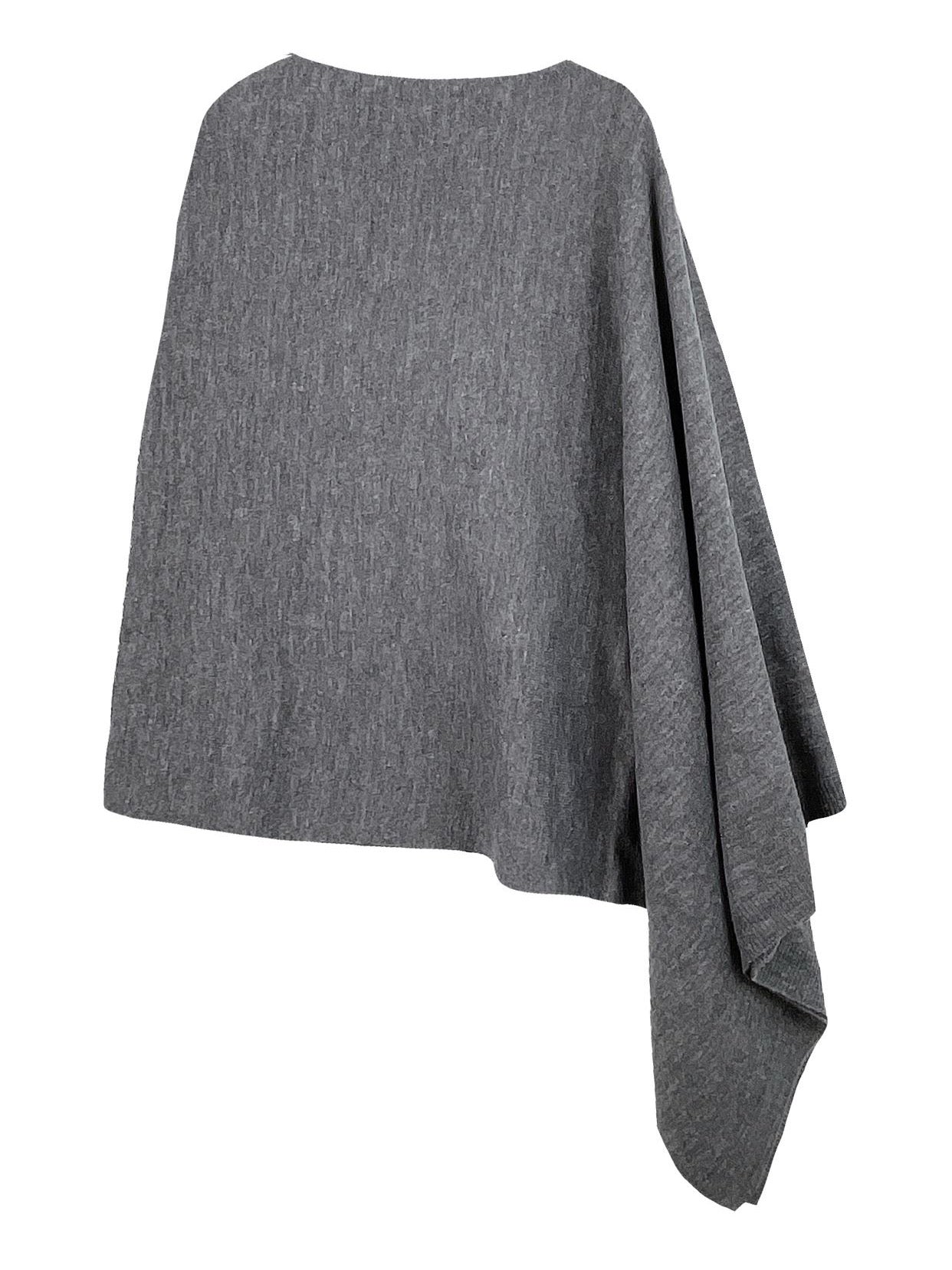 Someone wearing the Take With Me Travel Poncho by Ellison + Young with plaid pants against a plain white background.