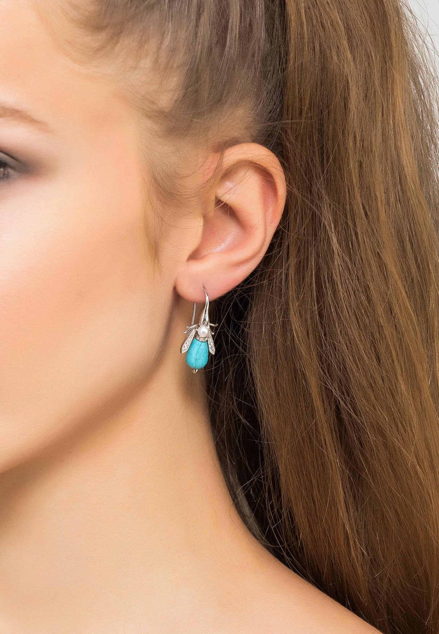 LATELITAs Turquoise Honey Bee Earrings feature a silver design with turquoise bodies and pearl accents.