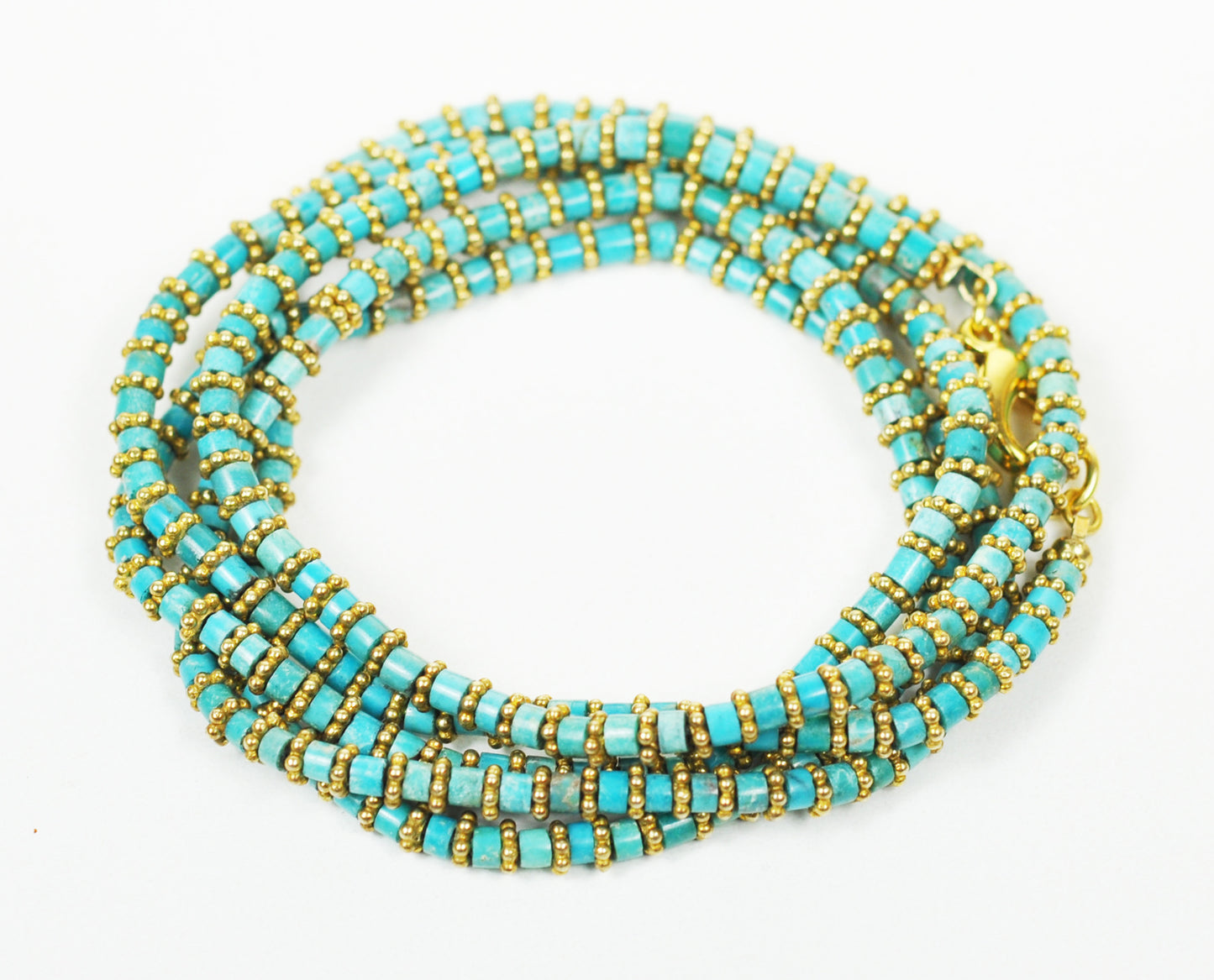 A Gena Myint Turquoise Wrap Bracelet with gold beads is set against a white background.