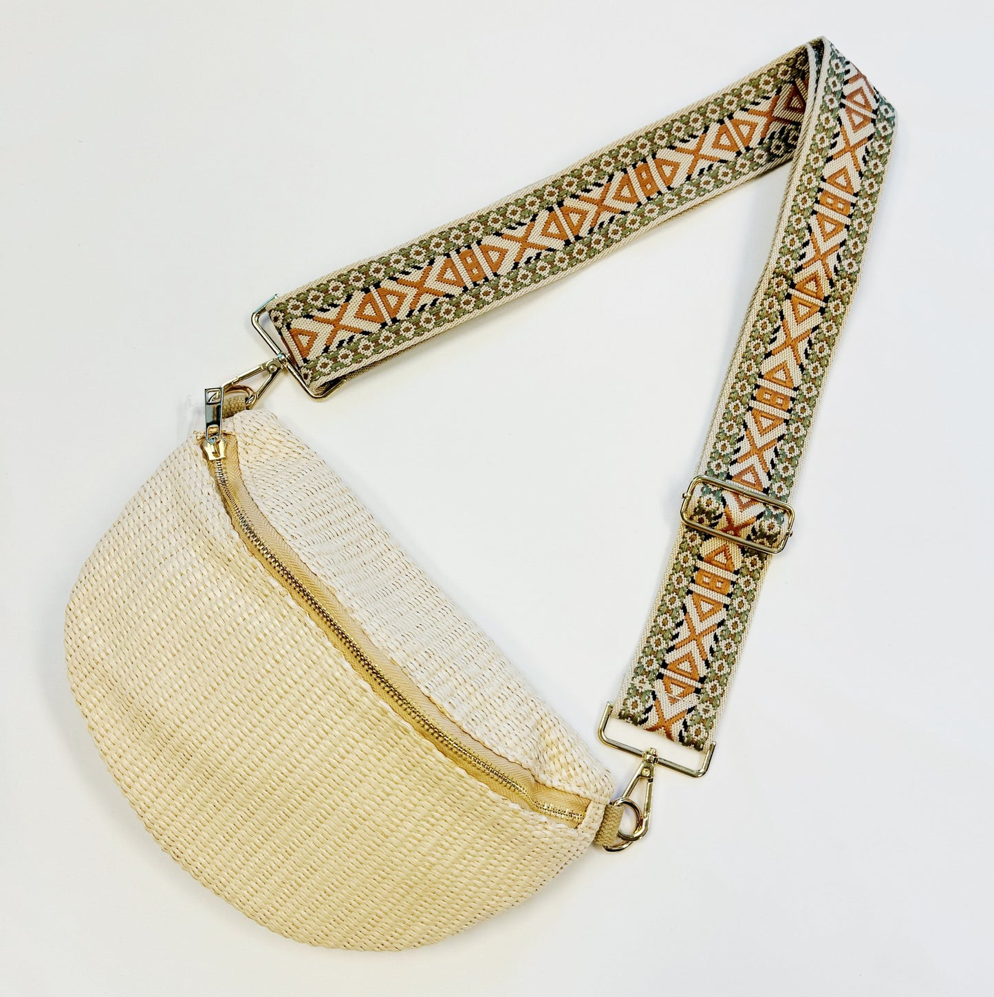 Four Bahama Breeze Fit All Sling Bags by Ellison + Young in pink, black, beige, and green with unique patterned straps are displayed on a white surface.