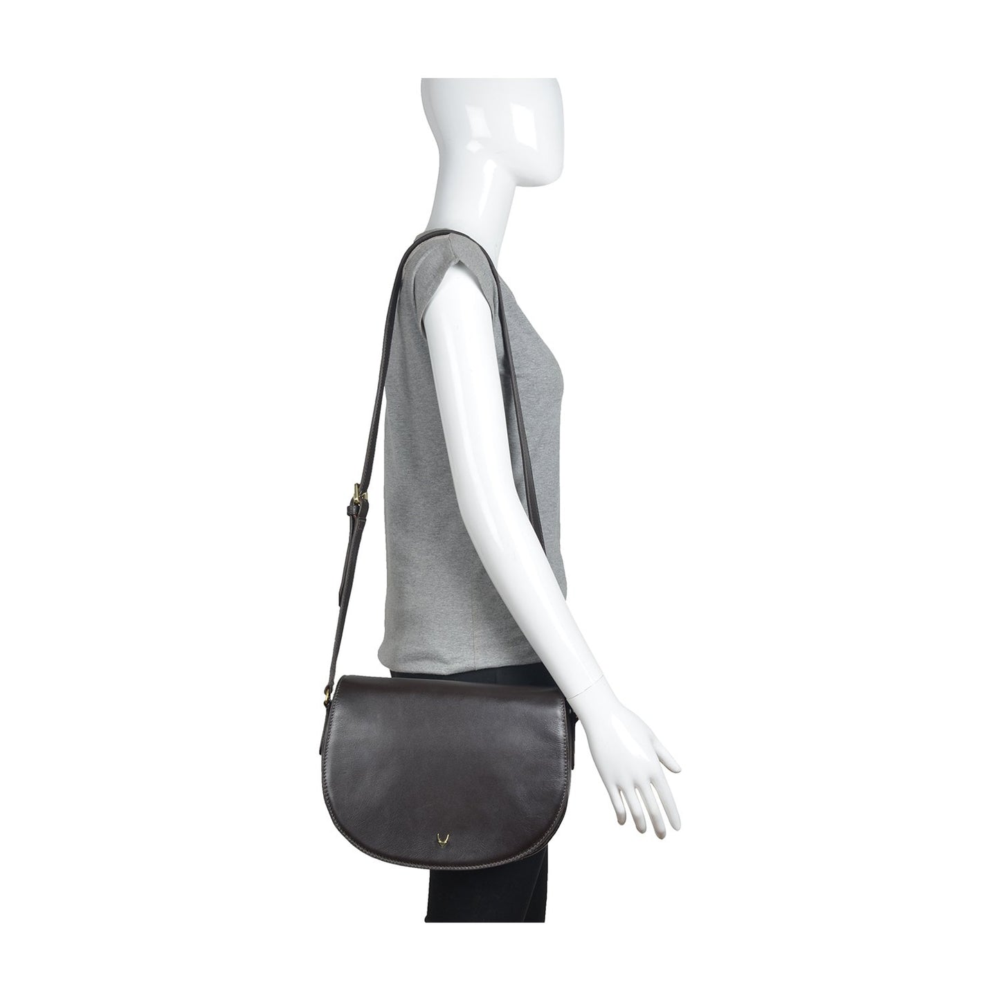 The Nelly Classic Leather Crossbody Bag by Hidesign features a black leather design with a flap closure and a gold buckle on the strap.