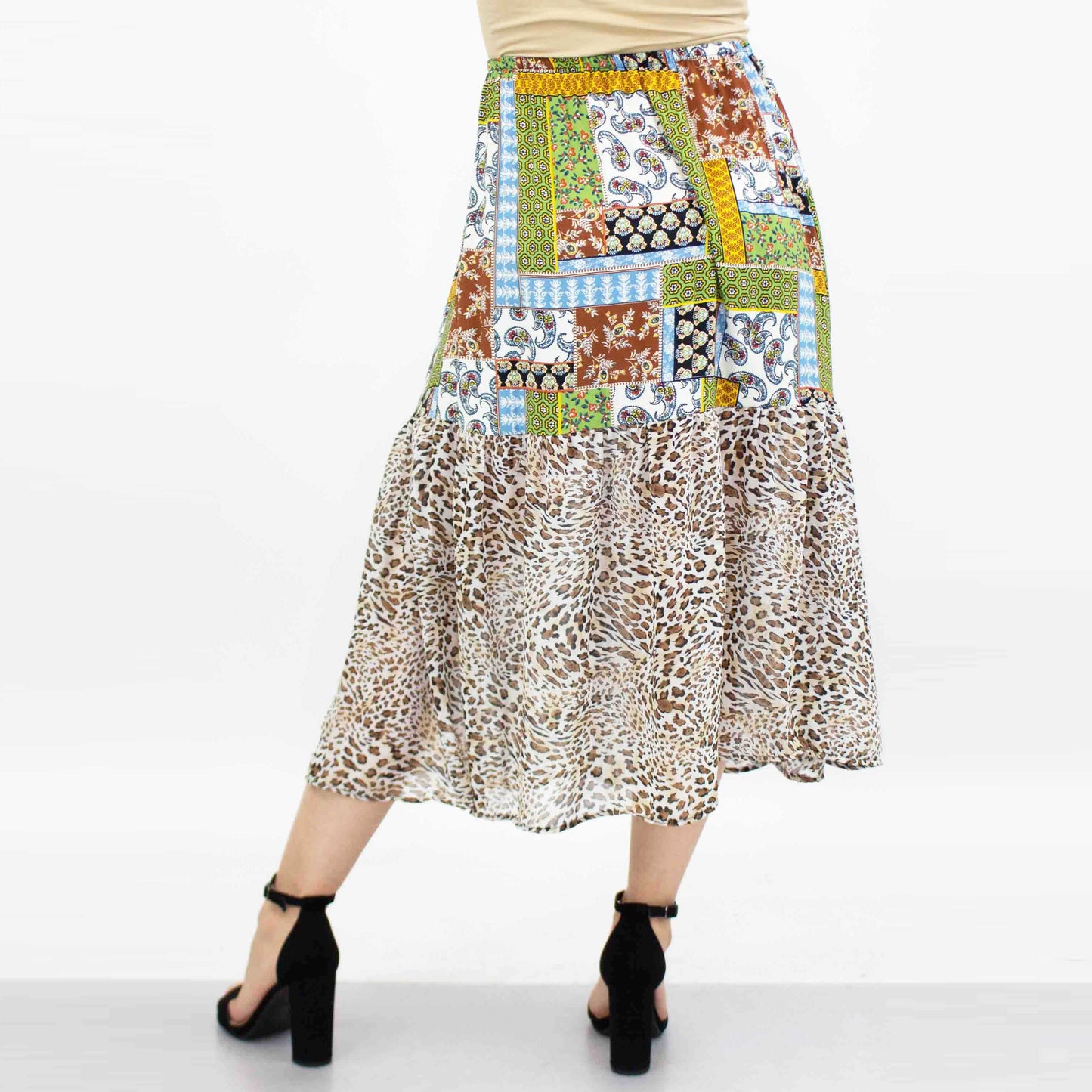 A model wears the Stylespect Animal Print Color Block Skirt in green with floral and animal prints.