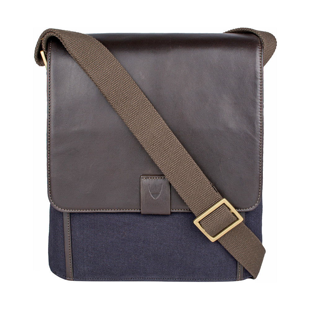 The Aiden Hidesign Blue Genuine Leather and Canvas Crossbody Bag features an adjustable strap and buckle, perfect for men or women as a shoulder, messenger, or travel bag that fits a 10.5 iPad.