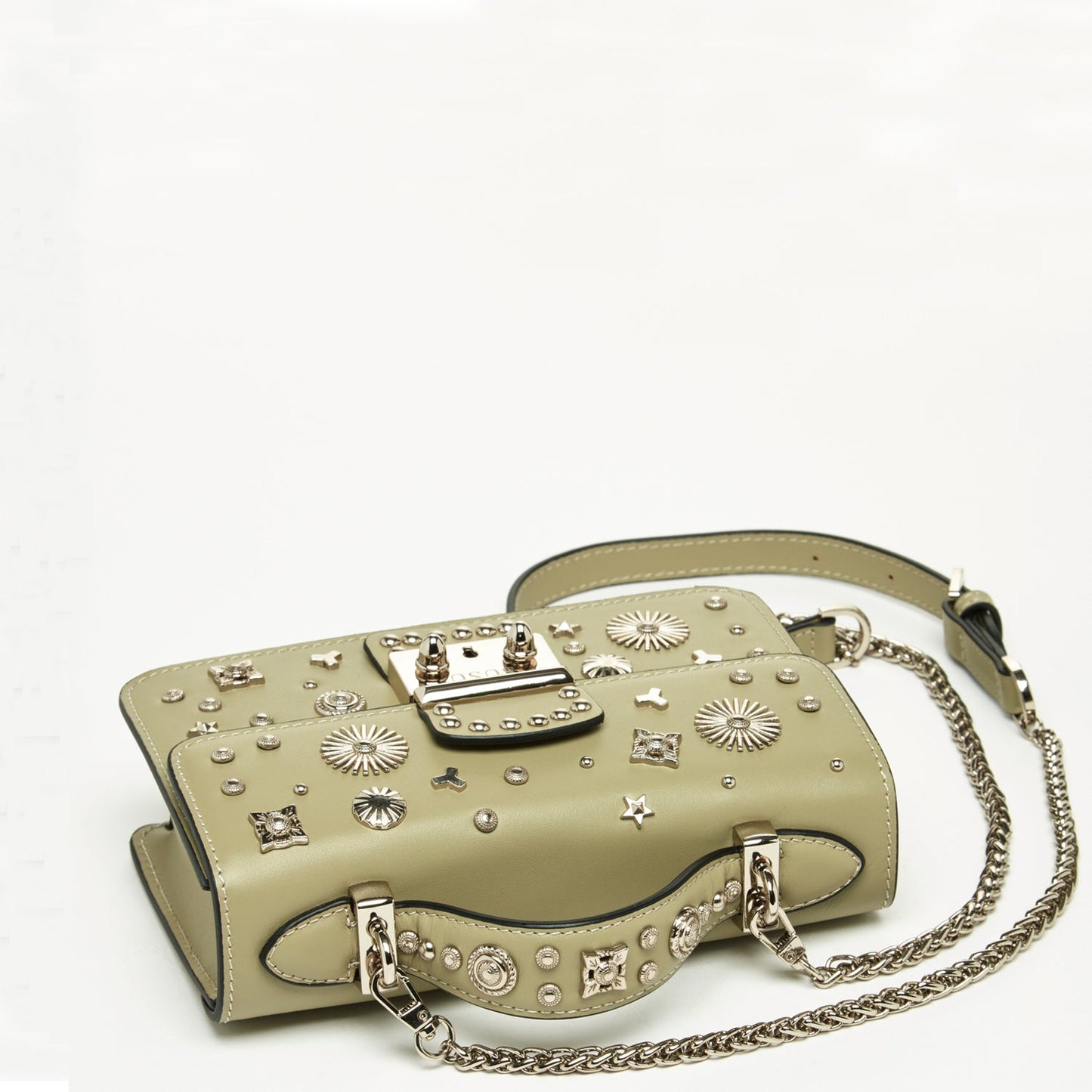 The Hollywood Leather Crossbody Bag by SUSU in sage green features metallic studs and chain straps, elegantly displayed against a plain background.