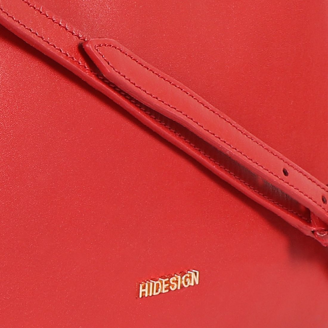 The Hidesign Life New Womens Leather Handbag is a red satchel with dual top handles, a detachable shoulder strap, gold-tone hardware, and the brand logo on the front.
