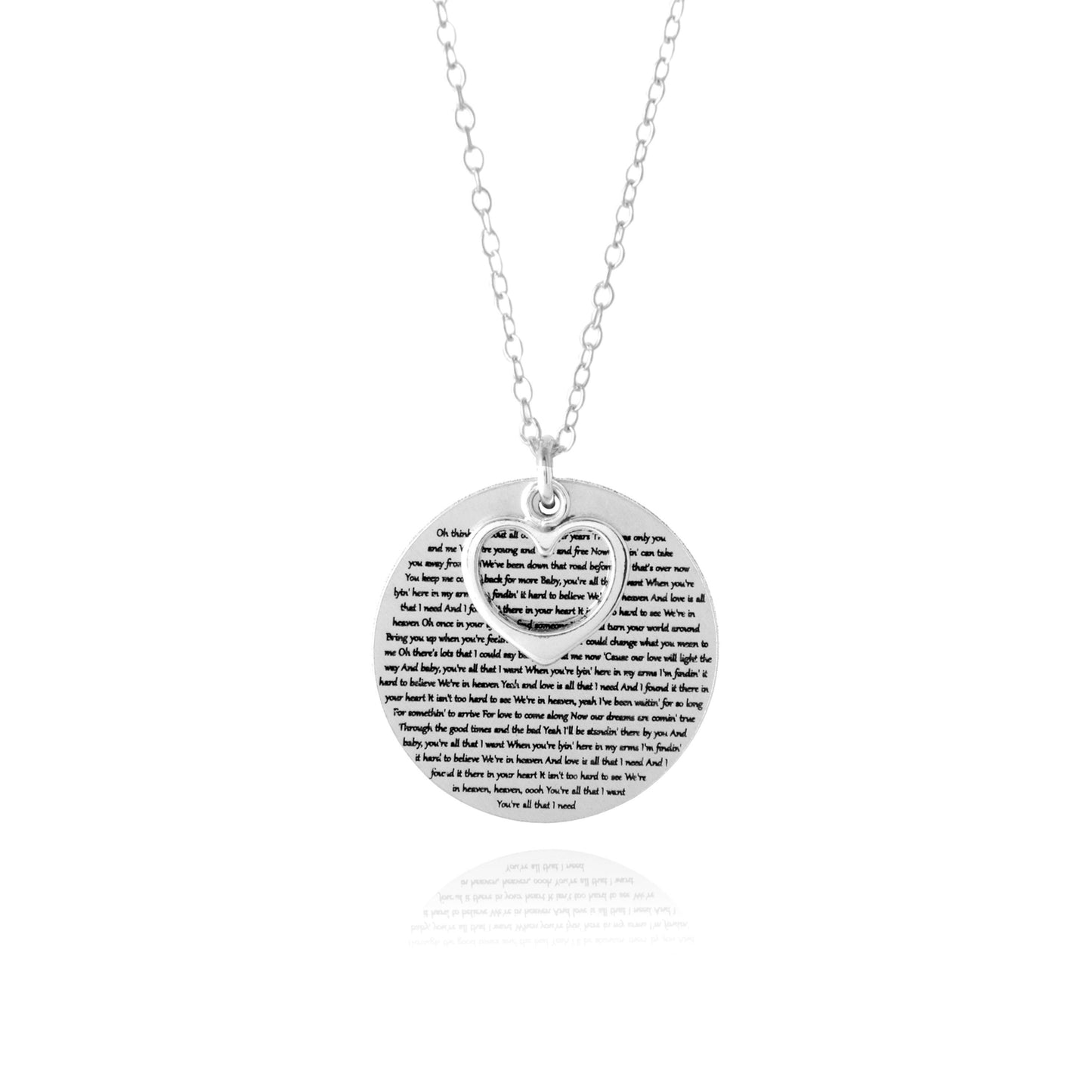 The Words of Love Necklace by Sincerely Silver is a silver piece with a round pendant showcasing printed text and an overlapping heart-shaped cutout.
