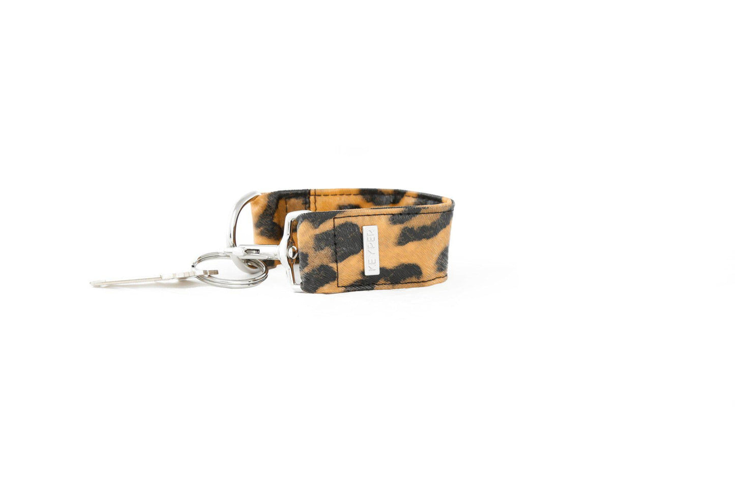 The KEYPER Brown Leopard Vegan Leather Key Ring is a wristlet keychain with a metal key and gold clasp.