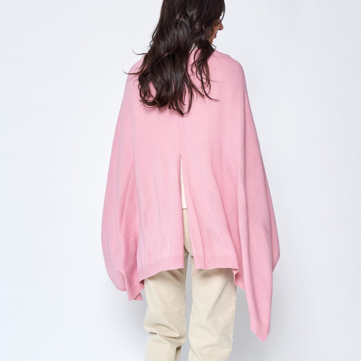Someone wearing the Take With Me Travel Poncho by Ellison + Young with plaid pants against a plain white background.