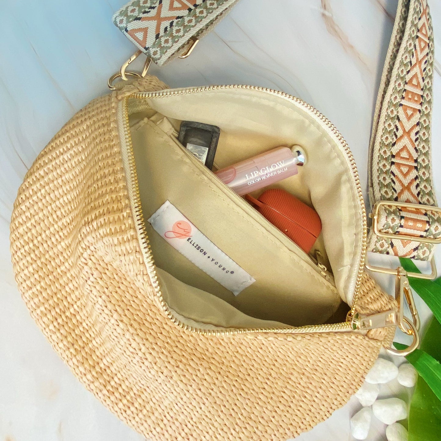 Four Bahama Breeze Fit All Sling Bags by Ellison + Young in pink, black, beige, and green with unique patterned straps are displayed on a white surface.