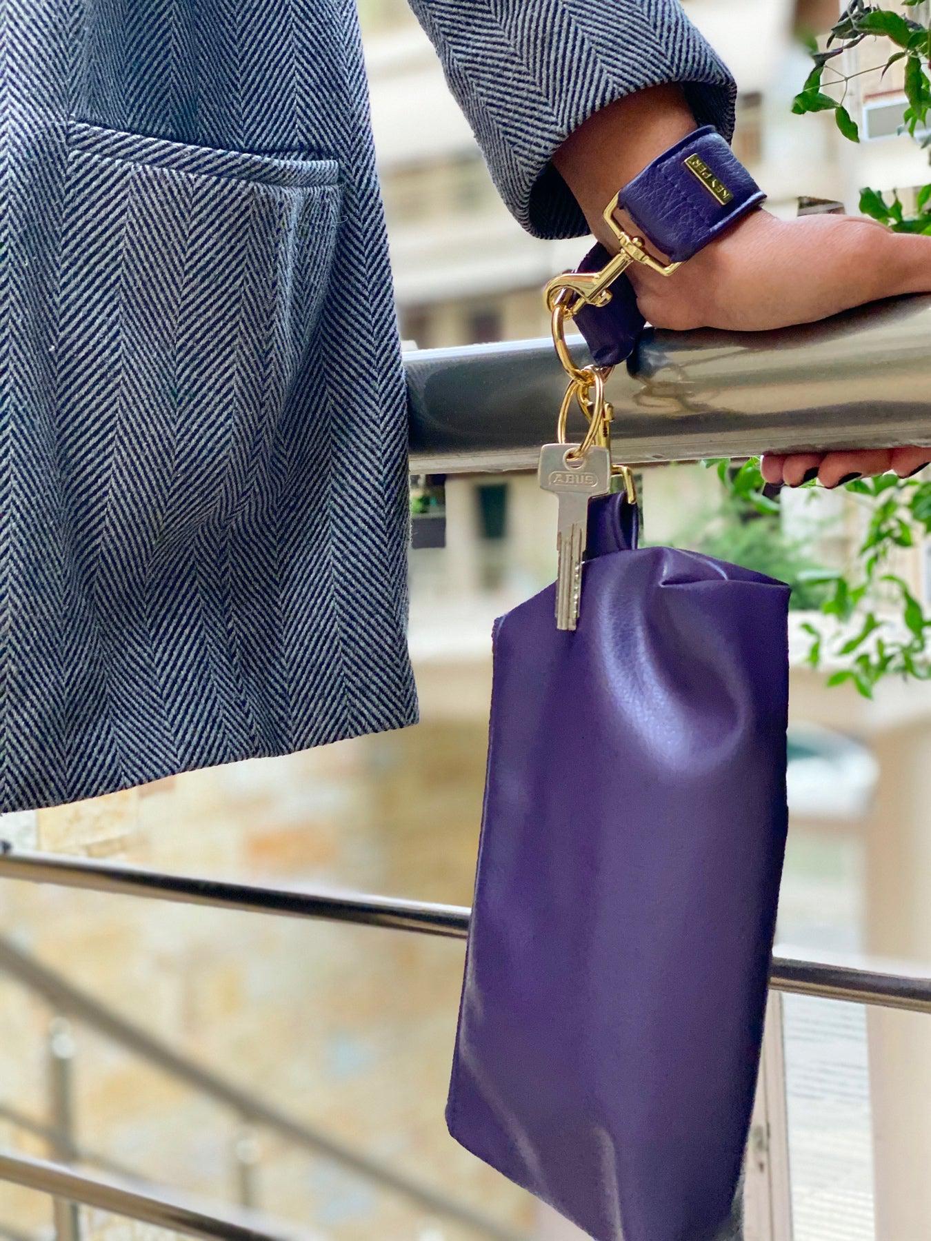 A Pretty Purple Vegan Leather Bag by KEYPER features a gold zipper and strap, showcased on a white background.