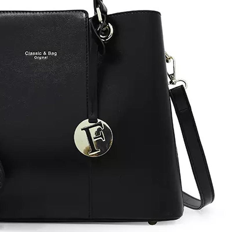 The Aaliyah Faux Crocodile Handbag Set (2-Pack) by Savoy Active includes a black handbag with a short handle, detachable shoulder strap, and circular charm, along with a matching textured wallet.