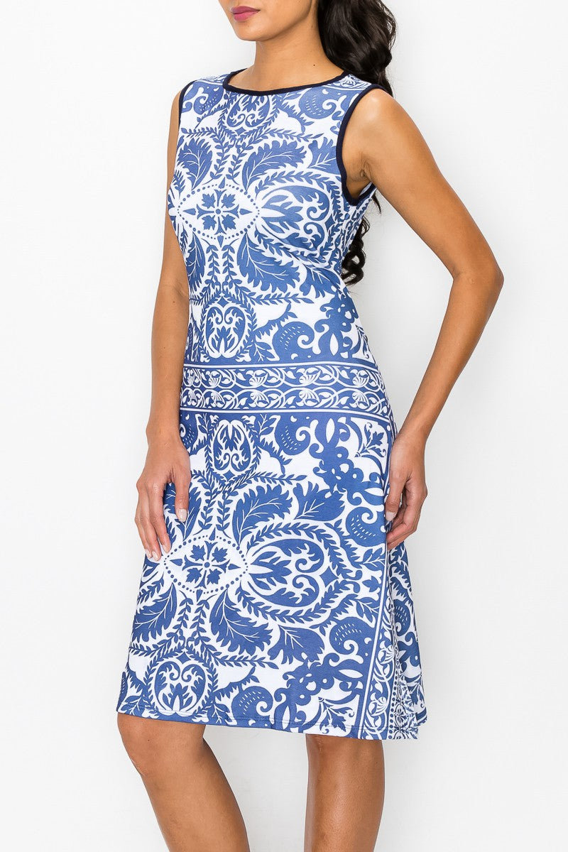 A woman stands against a plain white background, wearing the Stylespect Blue Graphic Print Sleeveless Dress.
