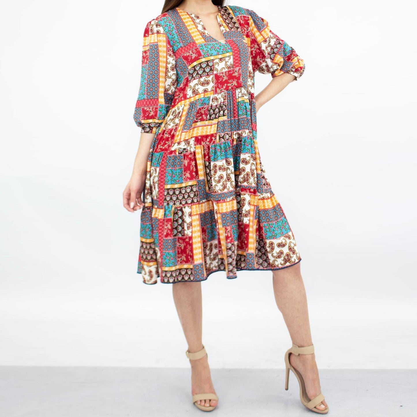 A person wearing the Stylespect Flare Bottom 3/4 Sleeve Dress in Red and beige high heels, standing against a plain background.
