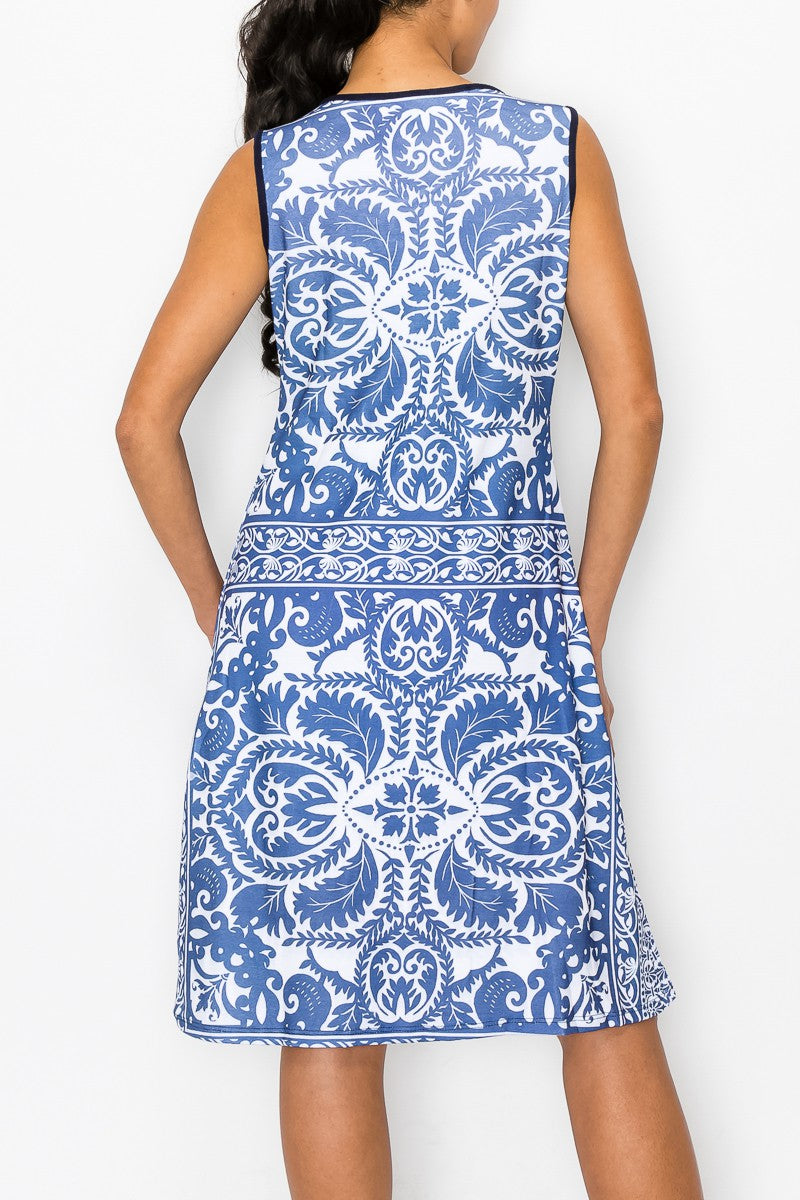 A woman stands against a plain white background, wearing the Stylespect Blue Graphic Print Sleeveless Dress.