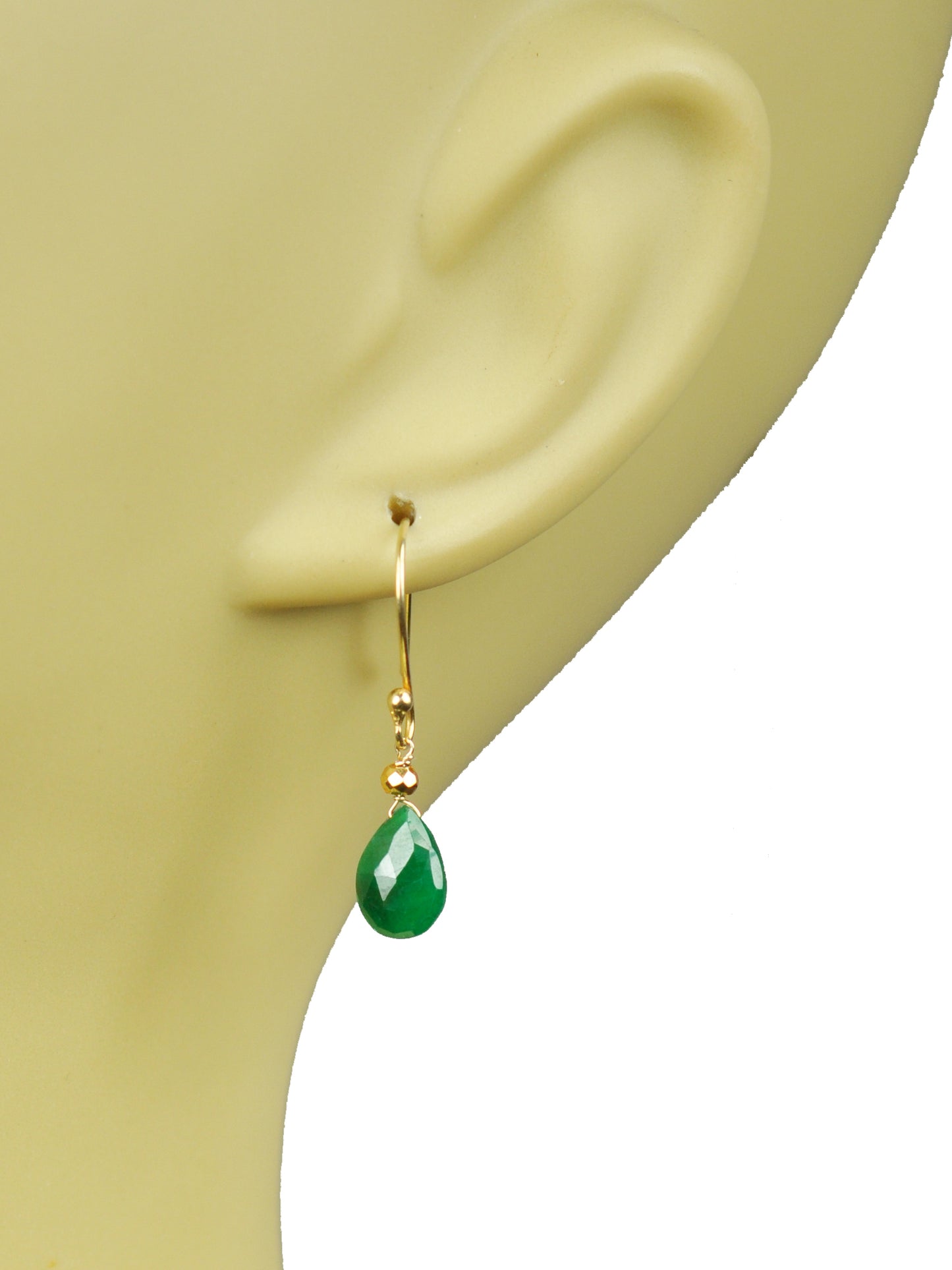 The Emerald Drop Vermeil Earrings by Gena Myint feature gold hooks with green teardrop-shaped gemstones and small clear stones above them.