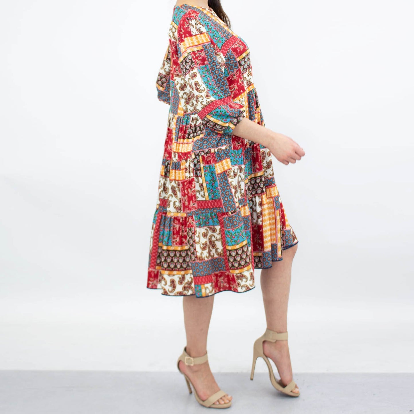 A person wearing the Stylespect Flare Bottom 3/4 Sleeve Dress in Red and beige high heels, standing against a plain background.