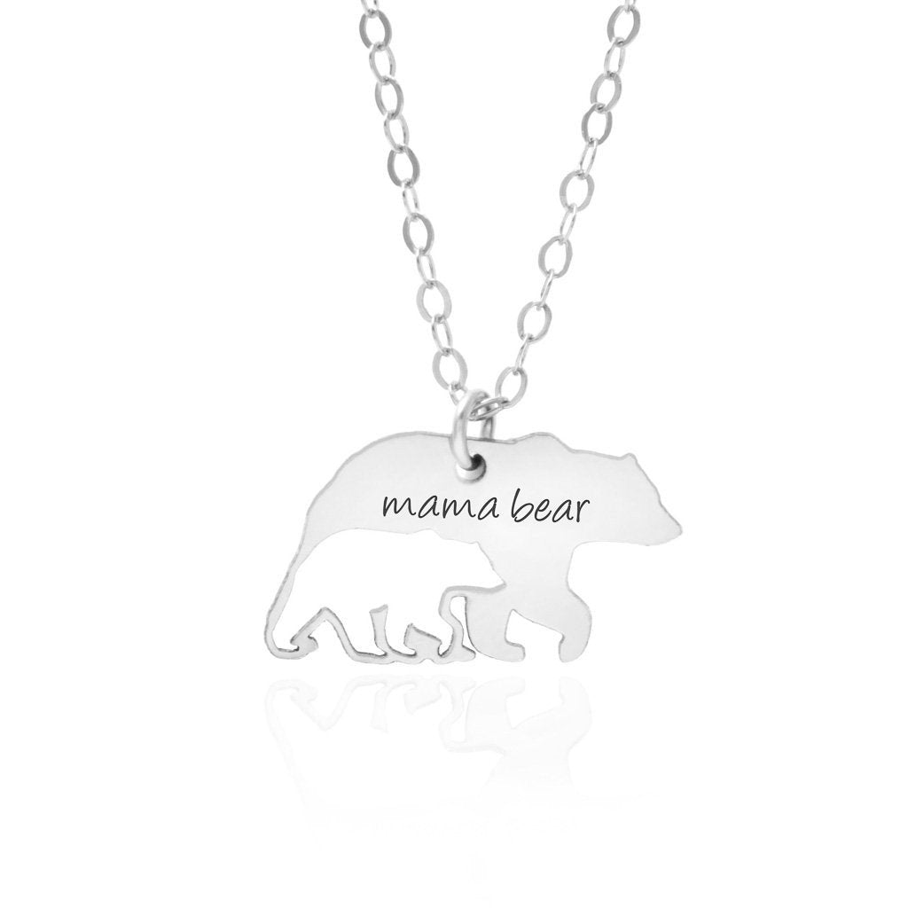 The Mama Bear and Cub Necklace by Sincerely Silver is a silver piece with a bear-shaped pendant featuring three cubs and inscribed with mama bear.