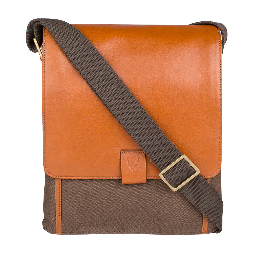 The Aiden Hidesign Blue Genuine Leather and Canvas Crossbody Bag features an adjustable strap and buckle, perfect for men or women as a shoulder, messenger, or travel bag that fits a 10.5 iPad.