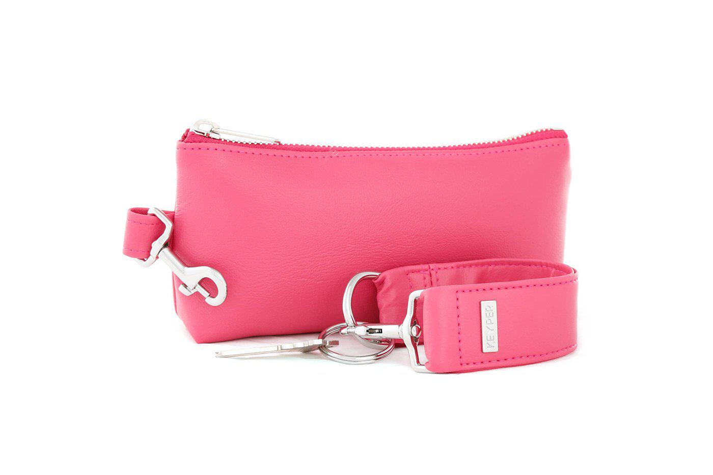 The KEYPER Bright Pink Vegan Leather 2-Piece WRISTLET SET includes a small pink pouch with a zipper, gold clasp, an attached pink strap, and a set of keys.