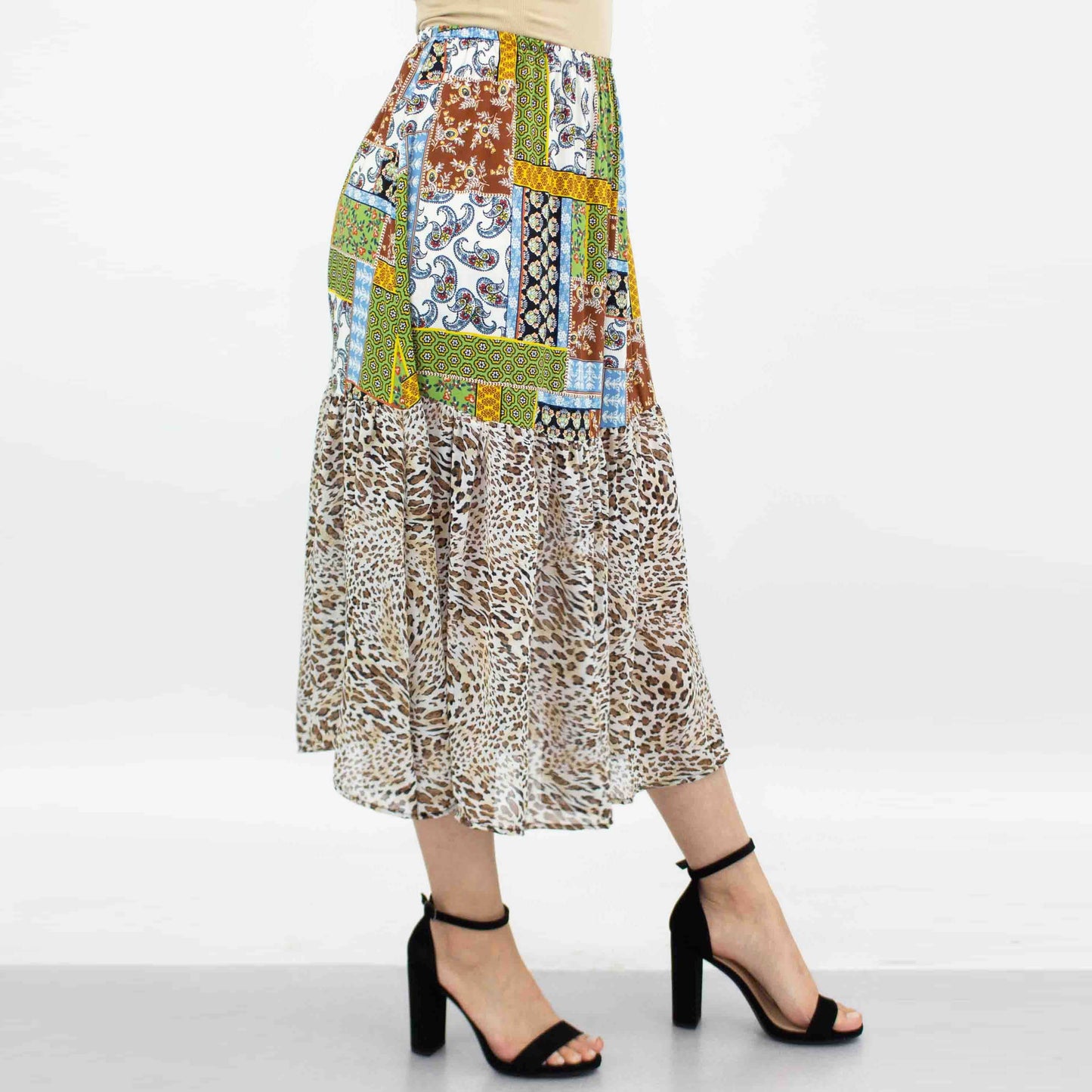 A model wears the Stylespect Animal Print Color Block Skirt in green with floral and animal prints.