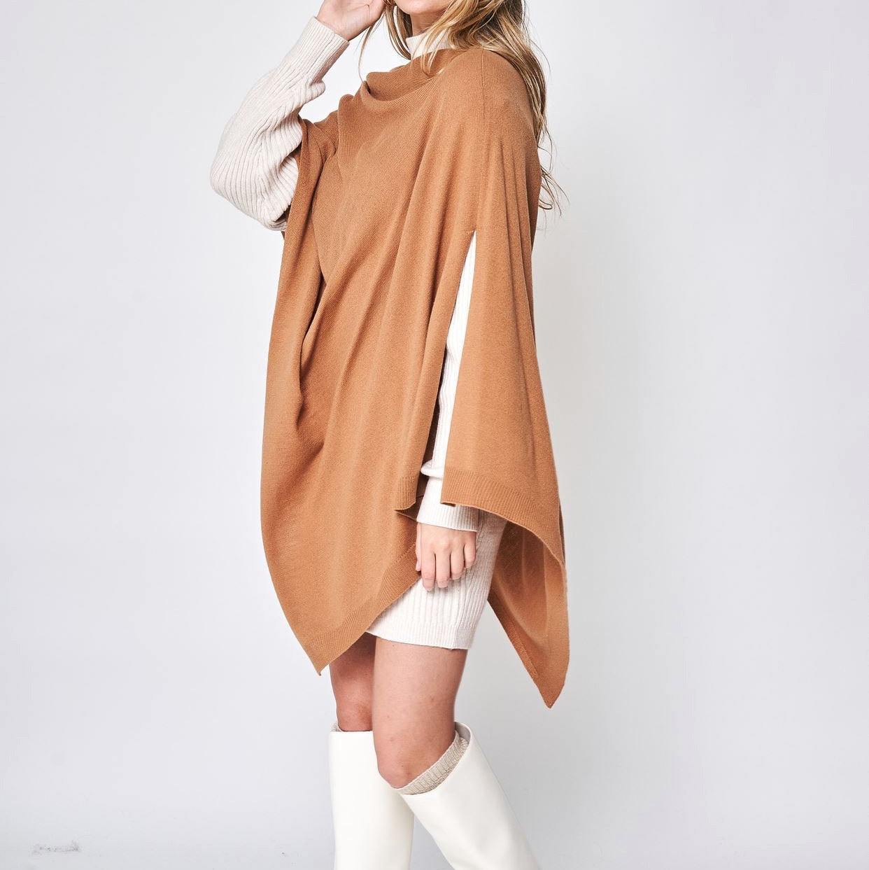 Someone wearing the Take With Me Travel Poncho by Ellison + Young with plaid pants against a plain white background.