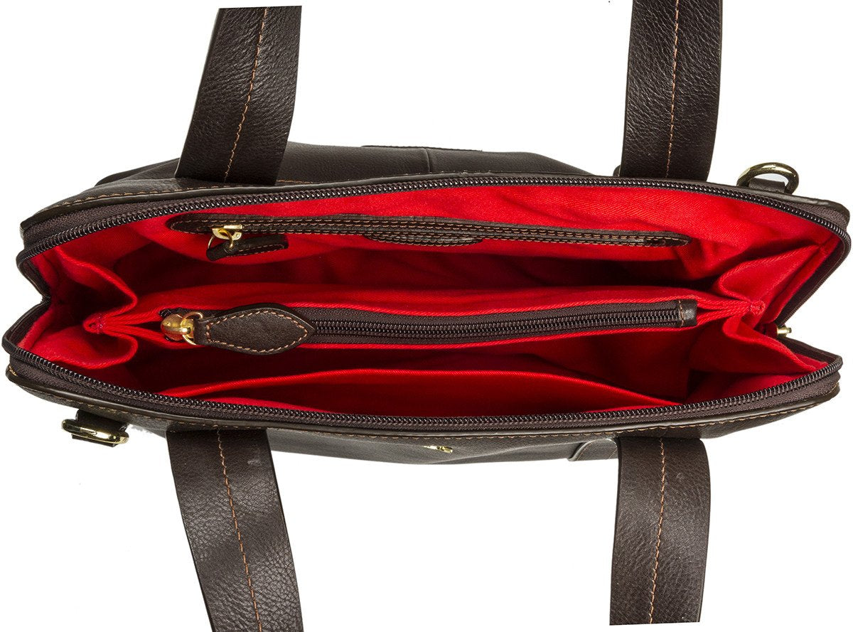 The Cerys Medium Leather Satchel by Hidesign is a red handbag with short handles and a detachable shoulder strap, featuring gold-tone hardware and a small gold emblem on the front.
