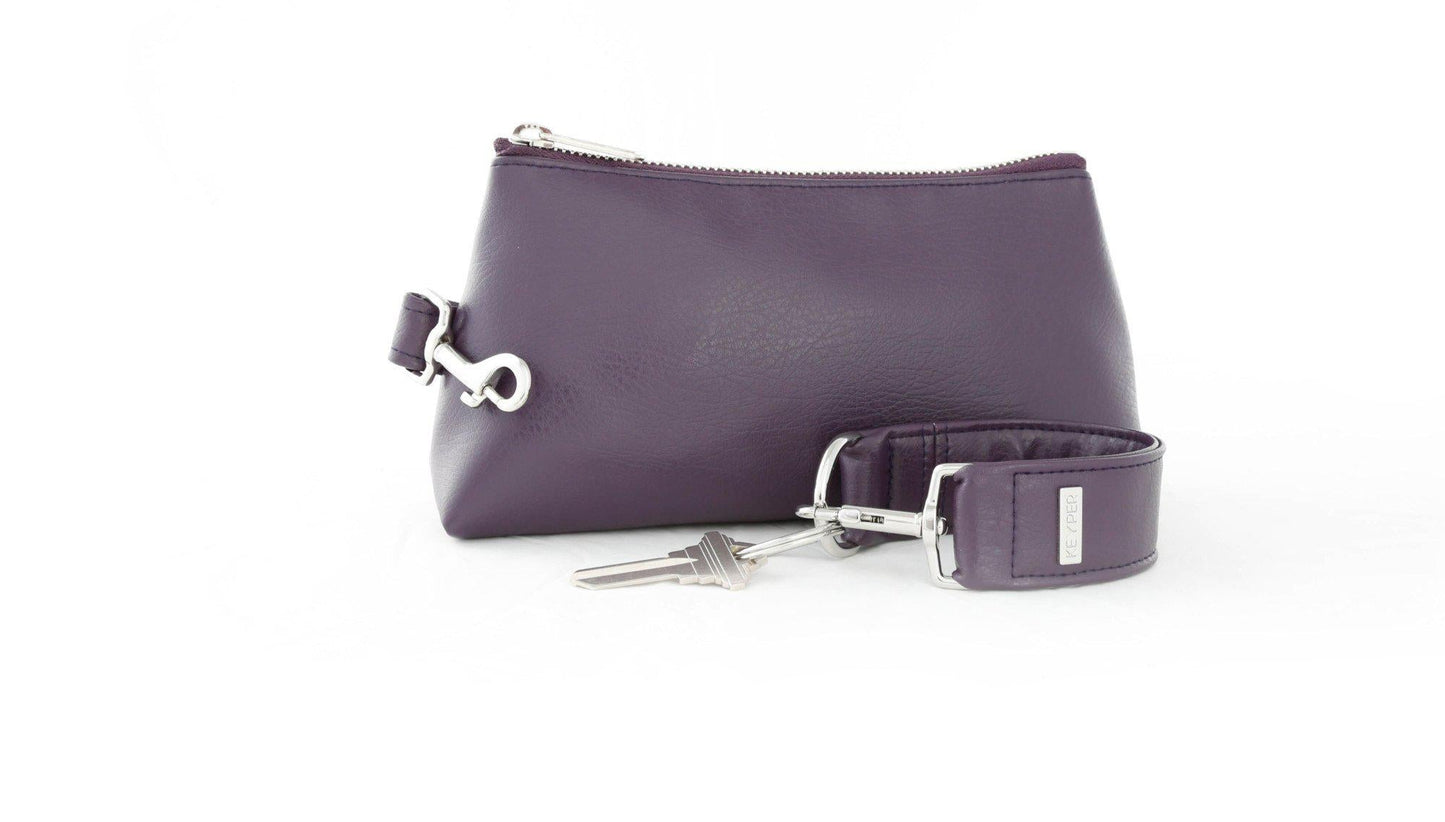 The Pretty Purple Vegan Leather 2-Piece WRISTLET SET by KEYPER features a wristlet with a zipper and gold accents, plus a detachable strap, and comes next to keys on a silver keyring.