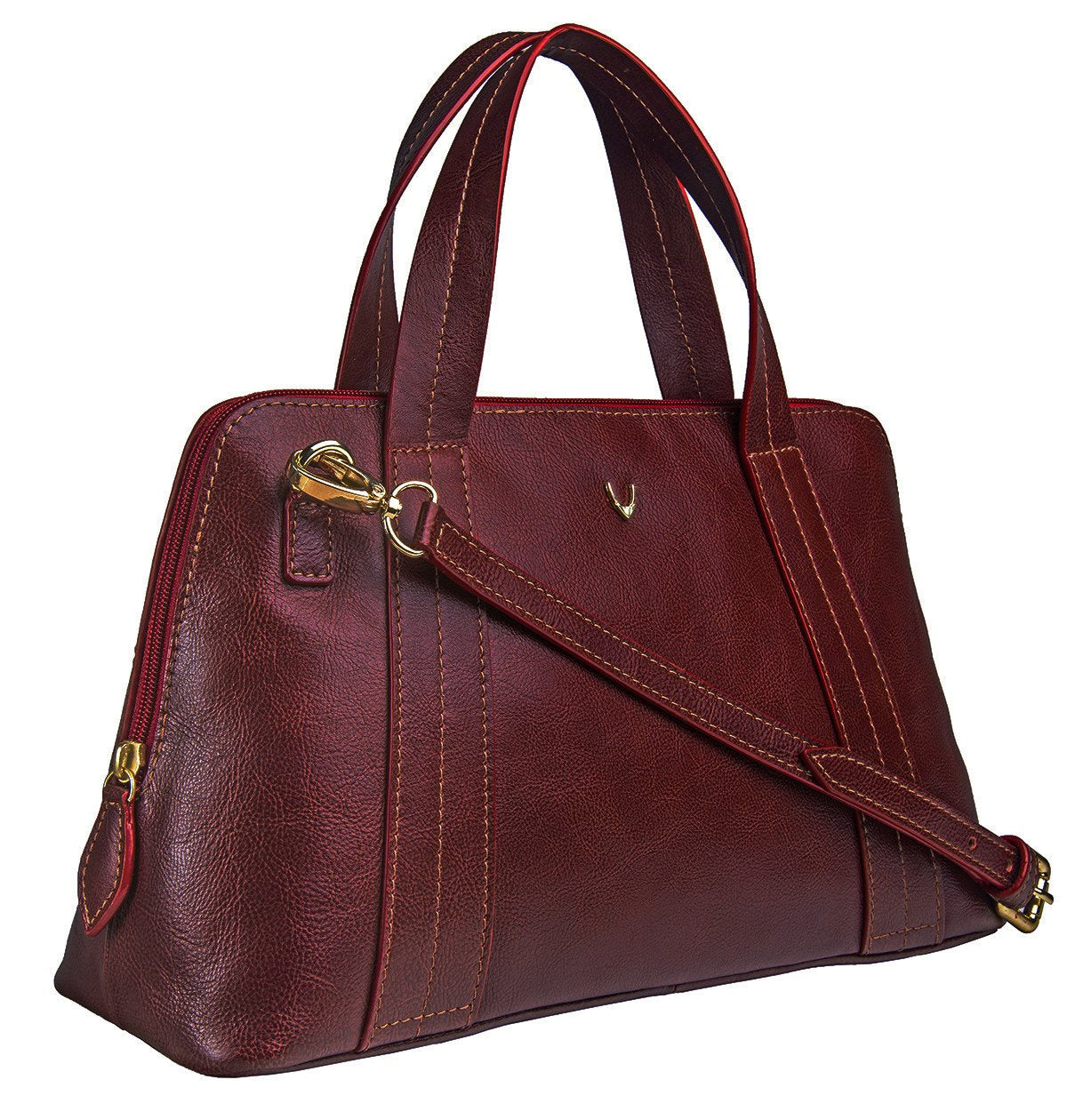 The Cerys Medium Leather Satchel by Hidesign is a red handbag with short handles and a detachable shoulder strap, featuring gold-tone hardware and a small gold emblem on the front.