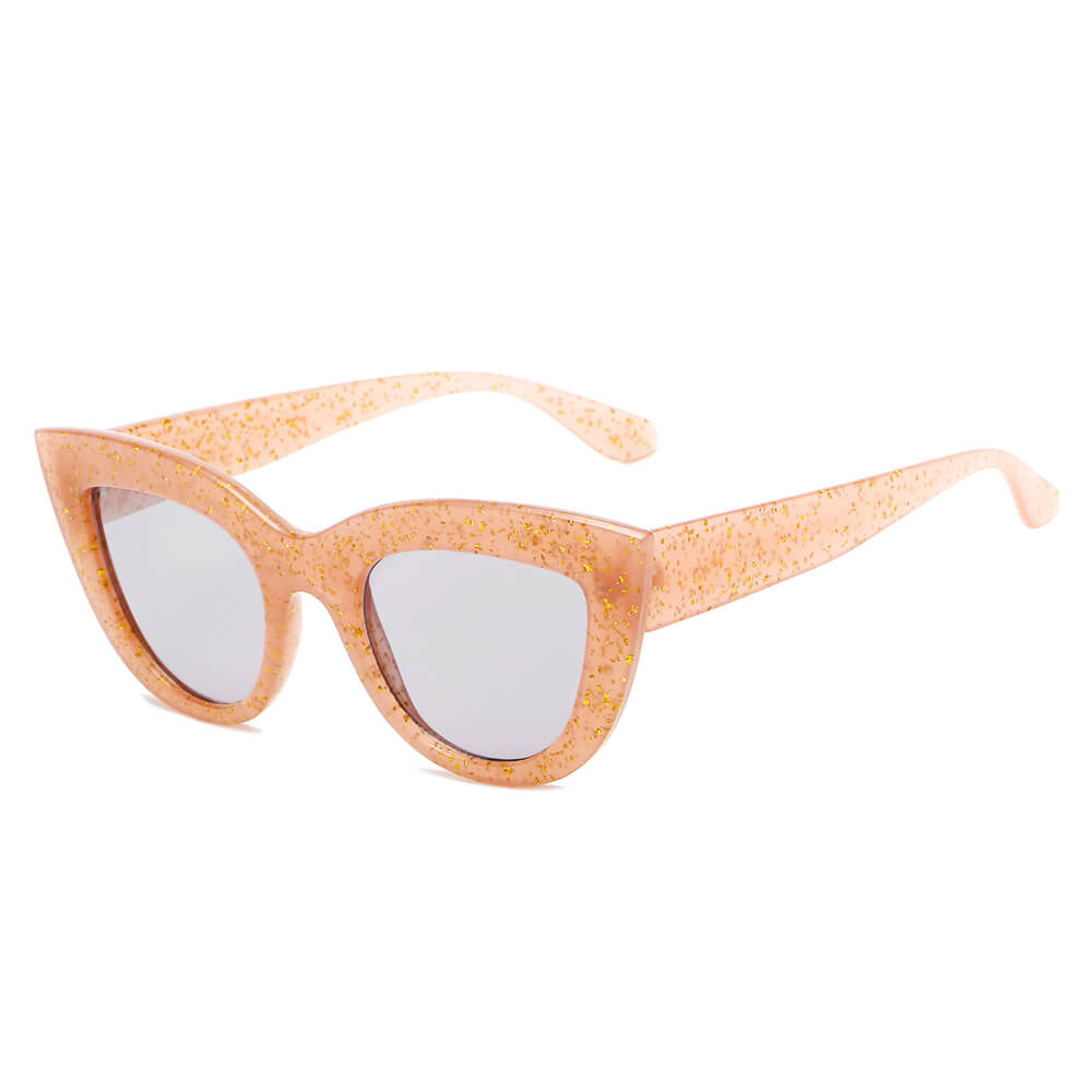 BOYDS women’s round cat-eye sunglasses by Cramilo Eyewear feature pink glittery frames and dark lenses on a white background.