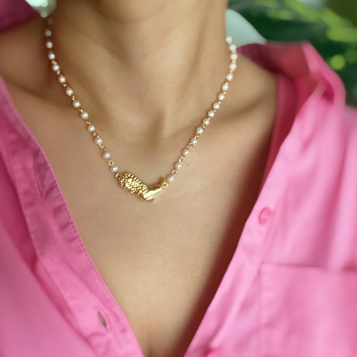 Ellison + Youngs Cowgirl Boot Pearl Chain Necklace is displayed on a marble surface.