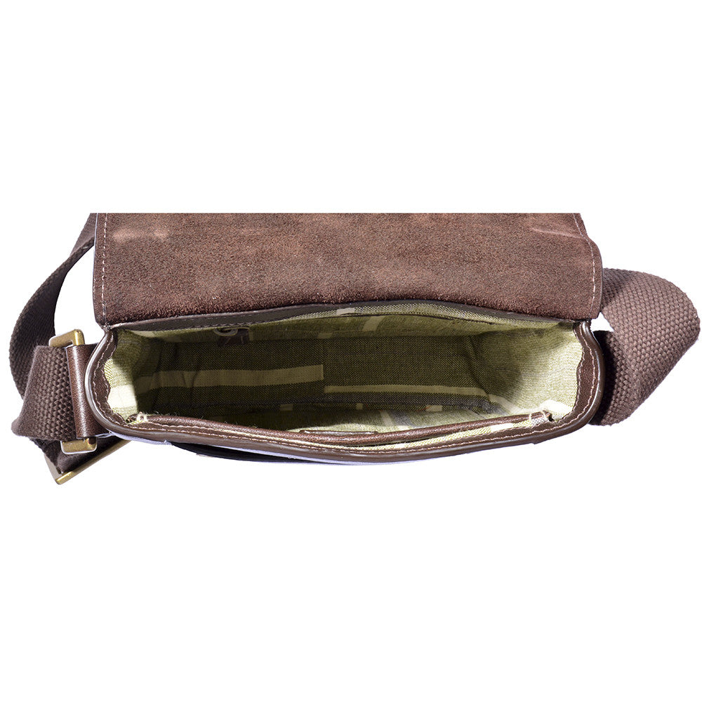 The Aiden Genuine Leather Mini Crossbody by Hidesign is a brown leather shoulder bag featuring a flap cover and an adjustable fabric strap with a brass buckle.