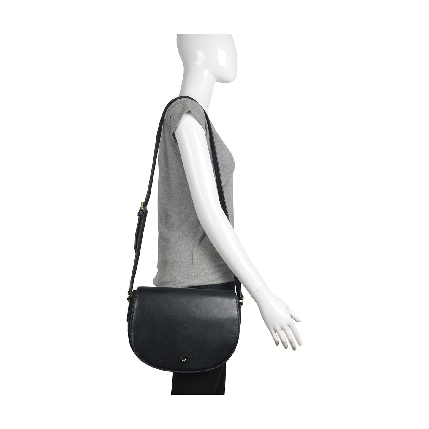 The Nelly Classic Leather Crossbody Bag by Hidesign features a black leather design with a flap closure and a gold buckle on the strap.