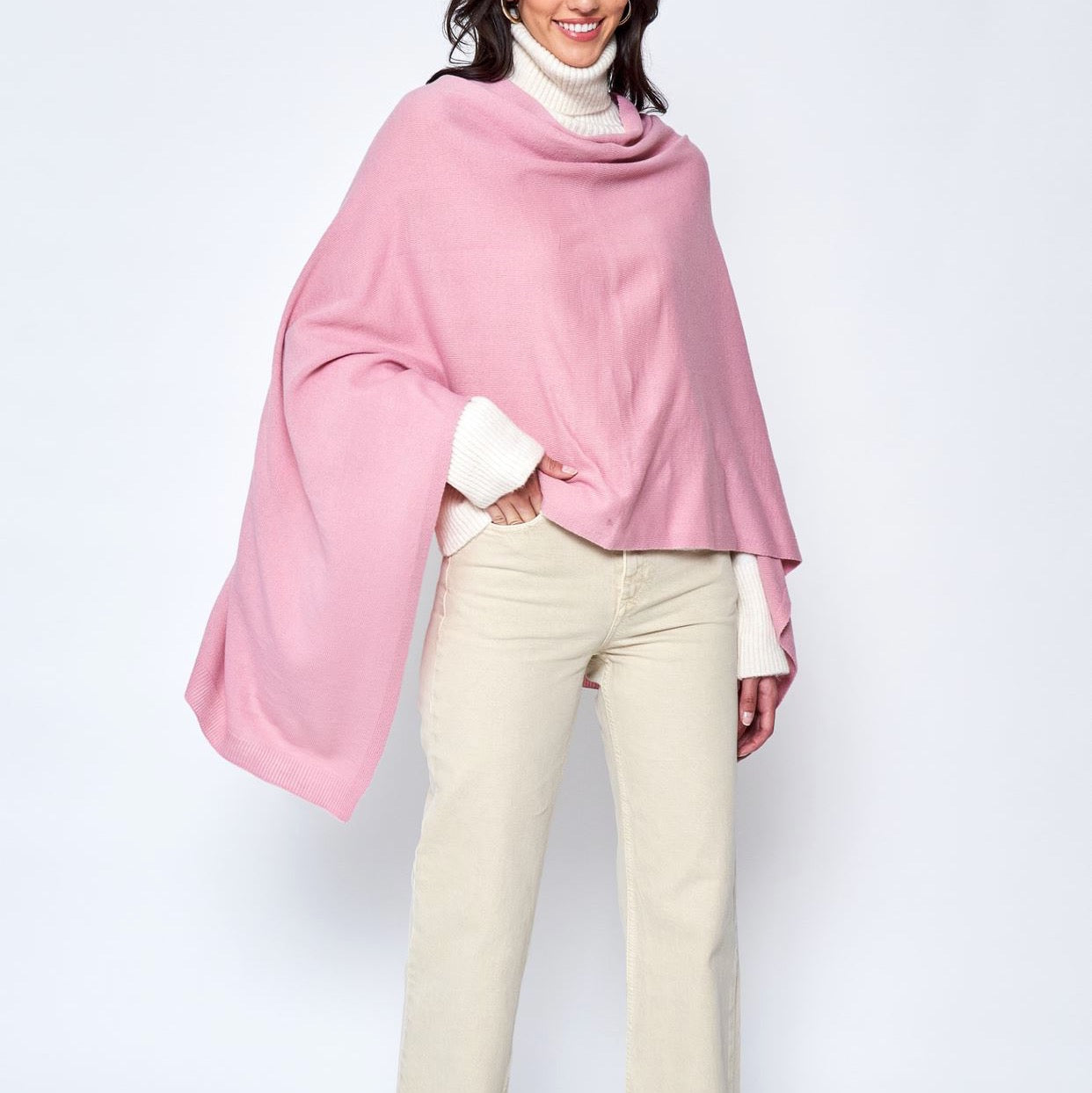 Someone wearing the Take With Me Travel Poncho by Ellison + Young with plaid pants against a plain white background.