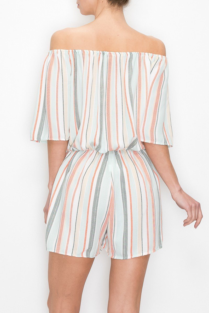 A person wearing an off-the-shoulder romper by Stylespect, featuring vertical stripes in white, pink, and light blue.