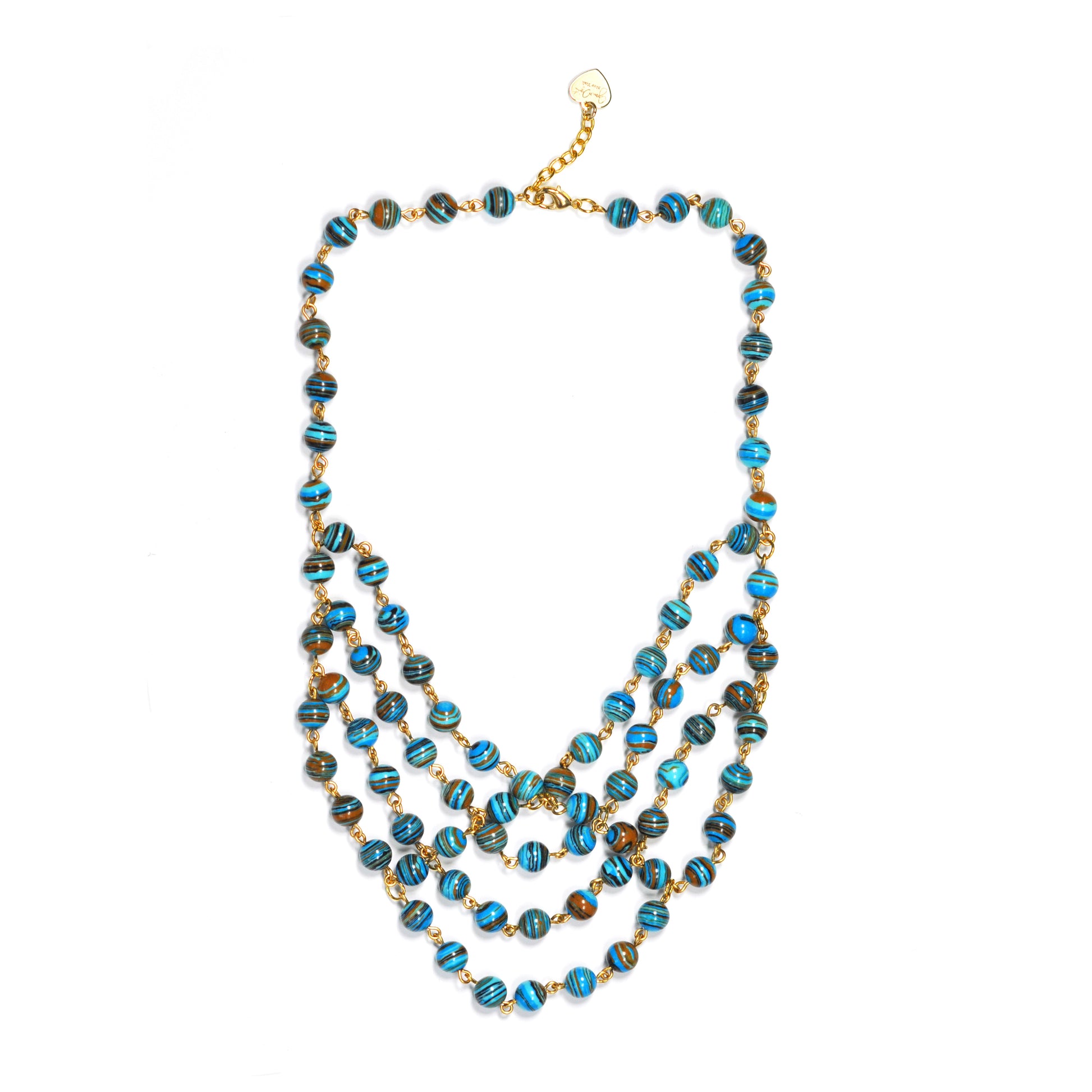 The Gena Myint Stripe Turquoise Statement Necklace features multiple strands with blue and brown marbled beads and a gold chain clasp.