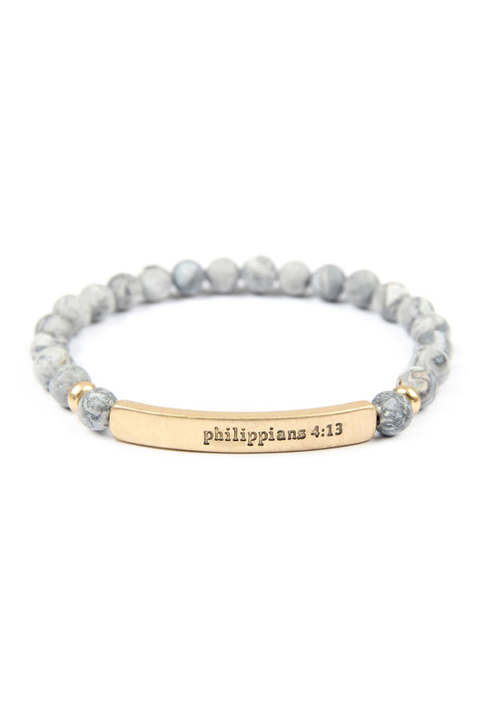 The Philippians 4:13 Natural Stone Stretch Bracelet by Riah Fashion features marble-like beads and a gold-tone bar engraved with Philippians 4:13. Color: Gold Gray.