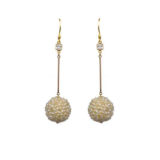 The White Topaz Pearl Cluster Ball Vermeil Earrings by Gena Myint showcase gold hooks adorned with round textured white beads and small square crystals.